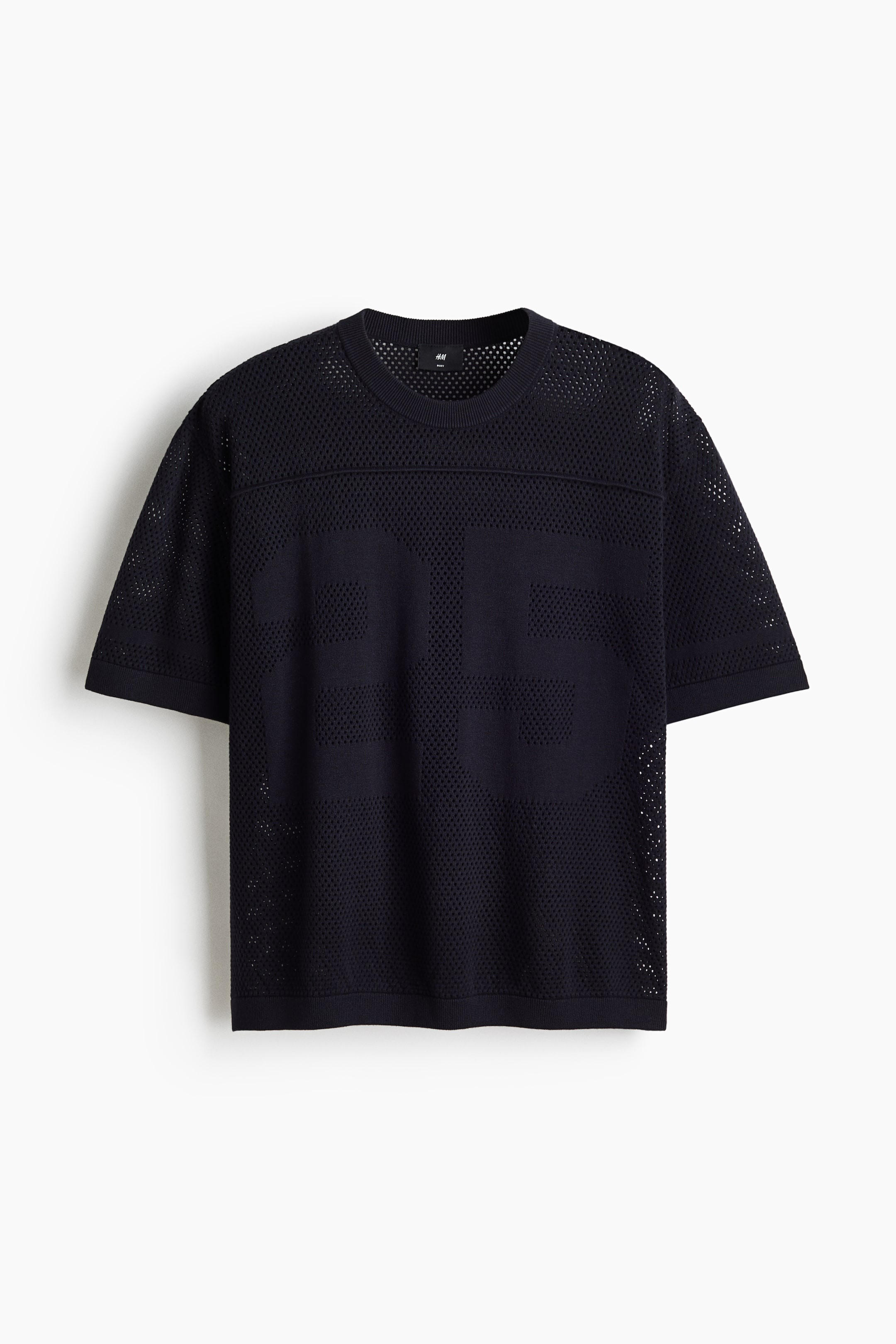 View larger image: The front view of a black mesh knit t-shirt showcases a crew neck and short sleeves, accented by ribbed bands on the collar, cuffs, and hem. The large numbers "26" are prominently displayed on the front in a denser knit, creating a striking contrast against the overall perforated design.