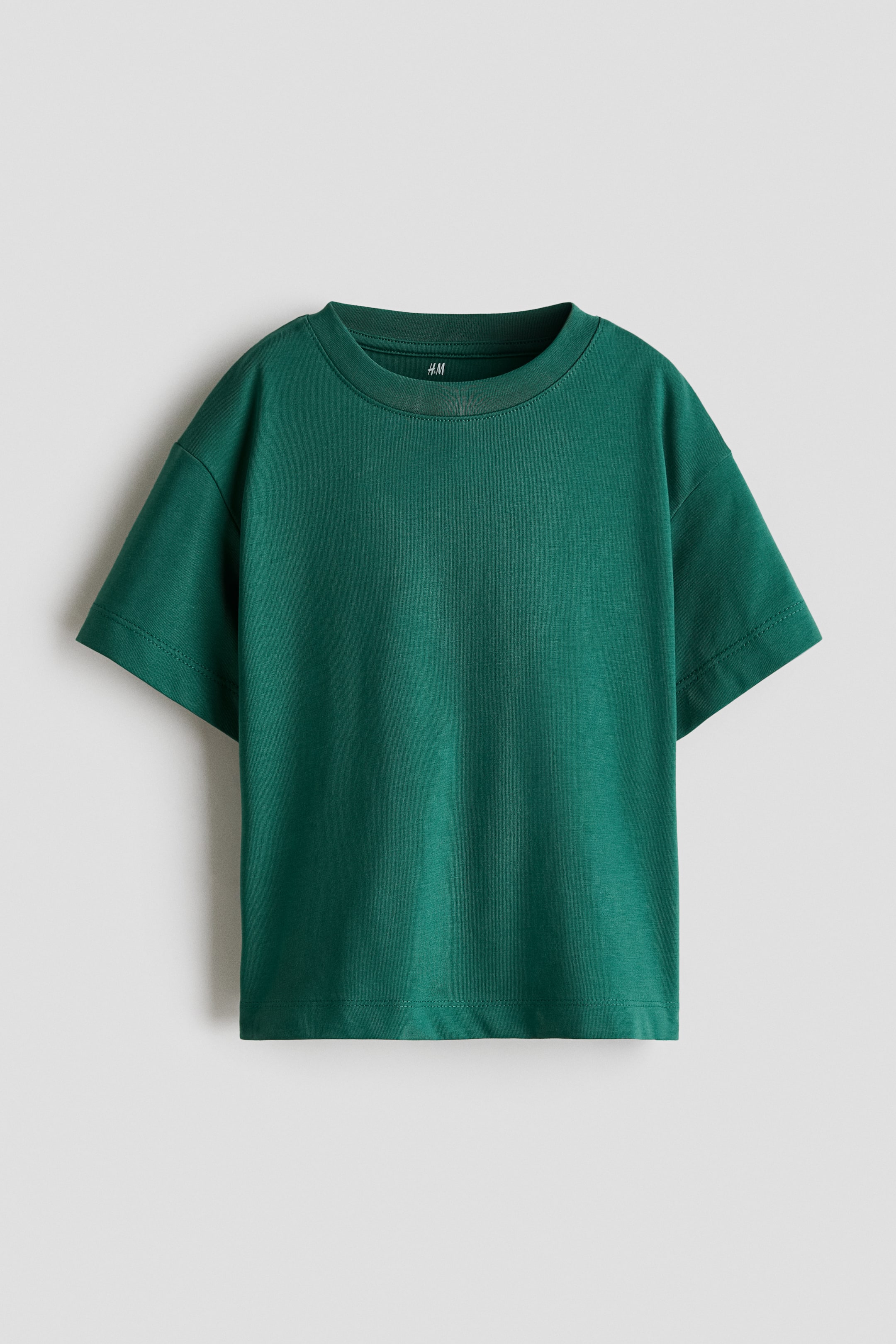 View larger image: A dark green short-sleeved T-shirt is shown from the front, featuring a relaxed fit with dropped shoulders and wide sleeves. The garment features a ribbed crew neck and a straight double-stitched hem.