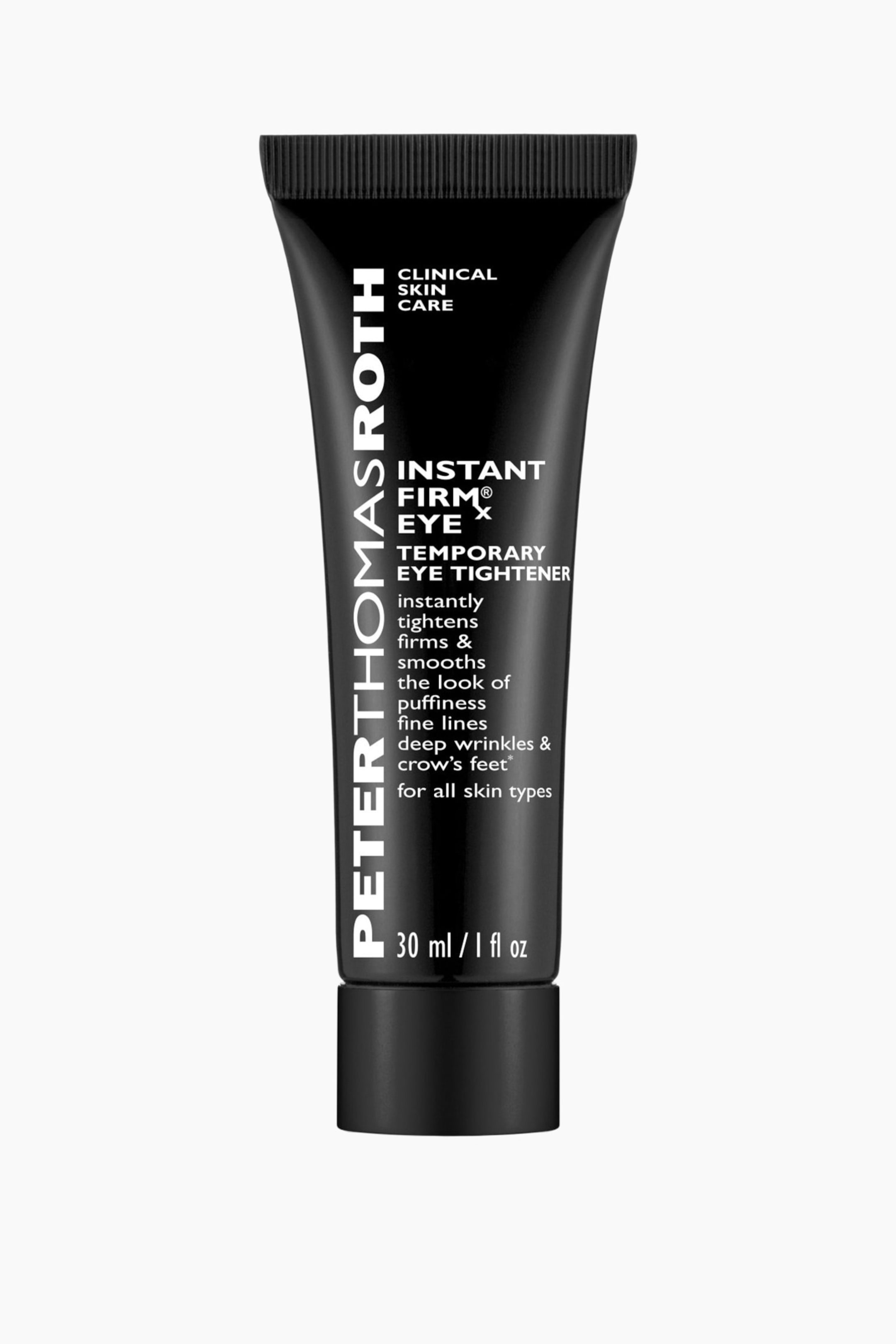 Se større billede: En tube Peter Thomas Roth Instant Firm Eye X Temporary Eye Tightener står opret med fronten vendt fremad. Den har en mat sort finish med hvid tekst, der angiver mærket, produktnavnet, nøglefordelene og volumenangivelsen 30 ml / 1 fl oz.