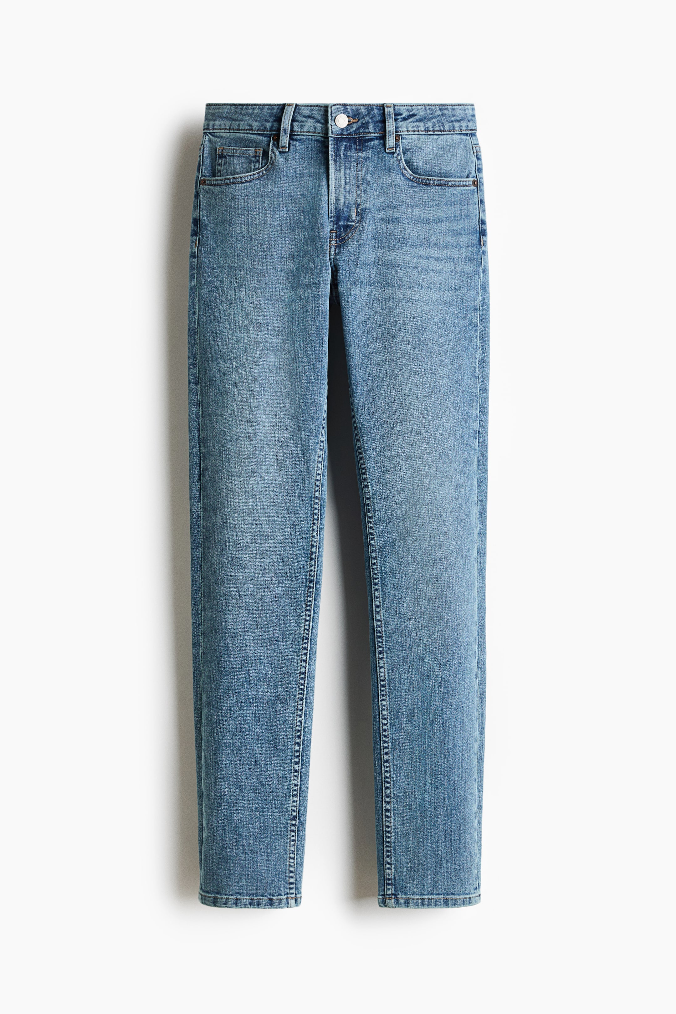 View larger image: The jeans are laid flat and facing forward, showcasing a light blue wash with subtle fading on the front. They feature a standard waist with belt loops, a white button and zip fly, and front pockets with a small coin pocket.