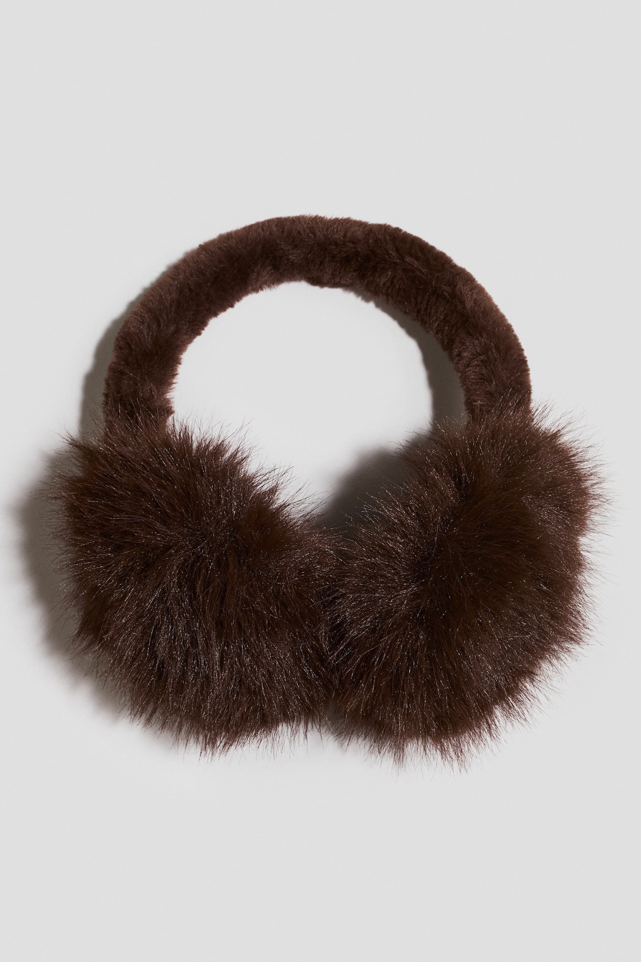 View larger image: Dark brown earmuffs featuring circular, fluffy ear cups and a fluffy headband, all covered in a soft, furry fabric.