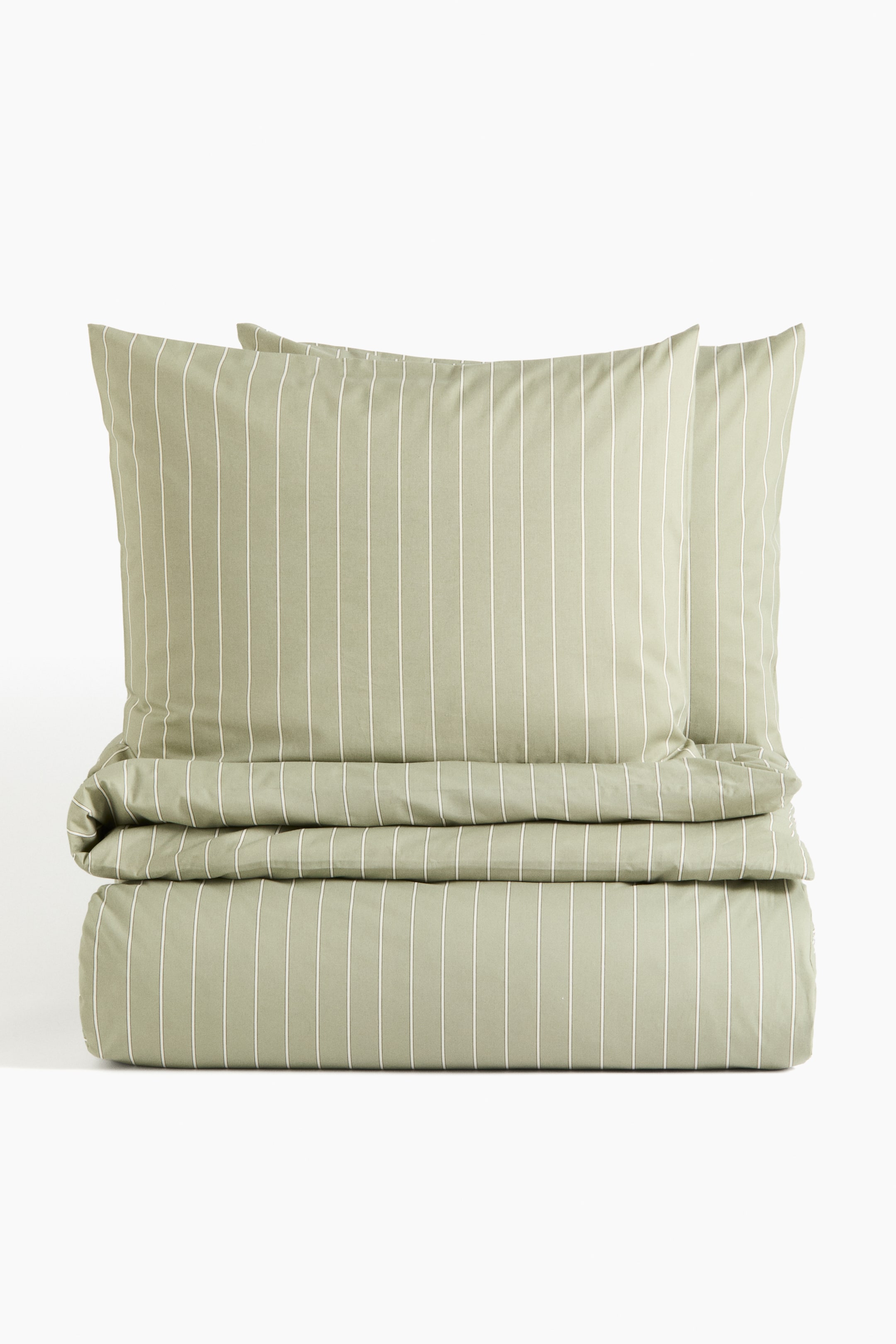 View larger image: The bedding set, shown from the front, includes two pillowcases and a folded duvet cover, all in a subtle green hue with fine, vertical white stripes.