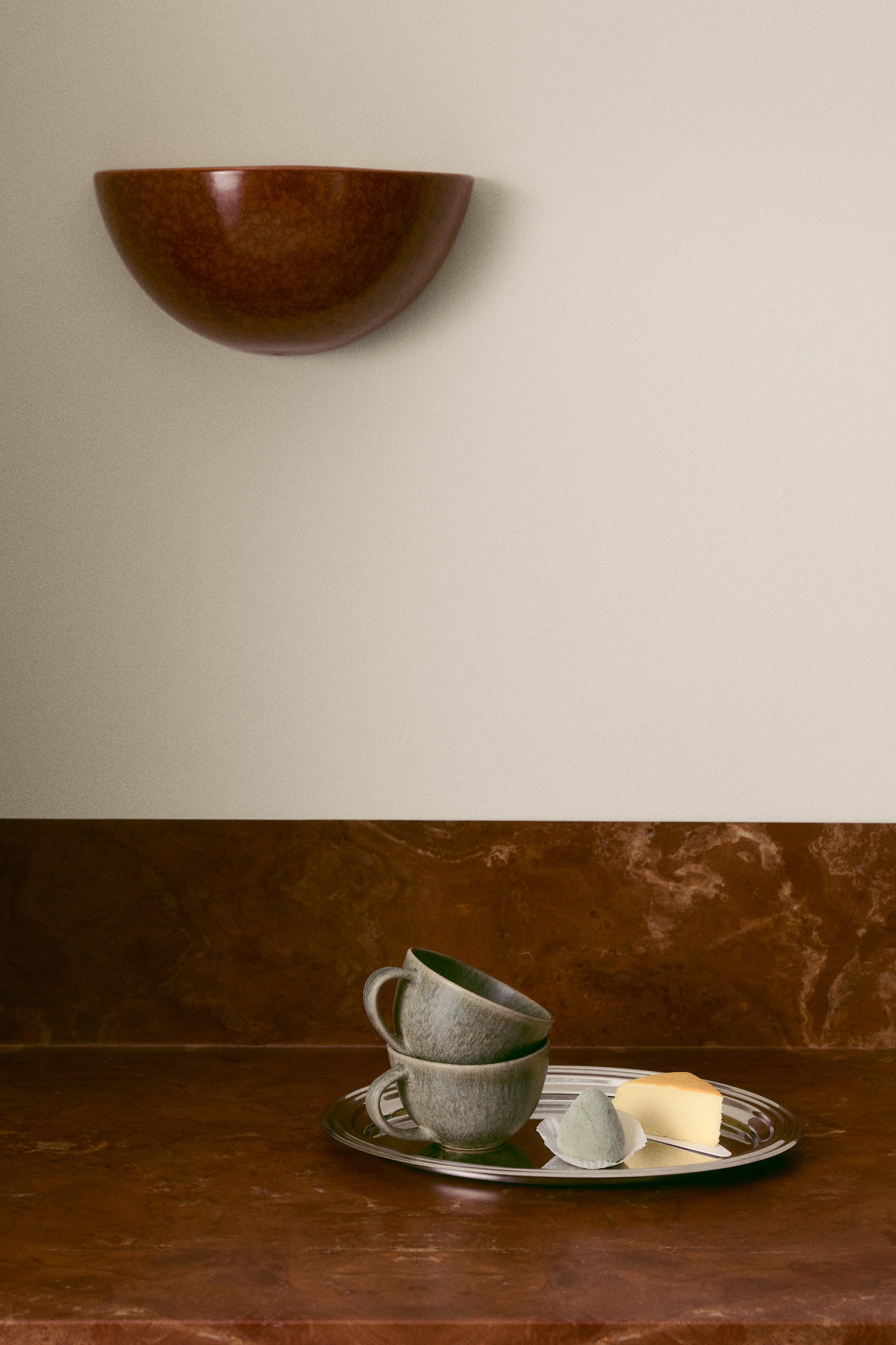 A ceramic cup is shown in side profile, featuring a wide, rounded bowl shape and a curved loop handle on the right. The cup has a textured, mottled grey-green glaze with subtle tonal variations. - 1