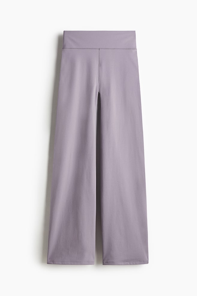 Light purple flared sports trousers are presenting a front view. They are featuring a wide, flat waistband and a prominent seam running down the center front, with the legs flaring out towards the hem. - 1