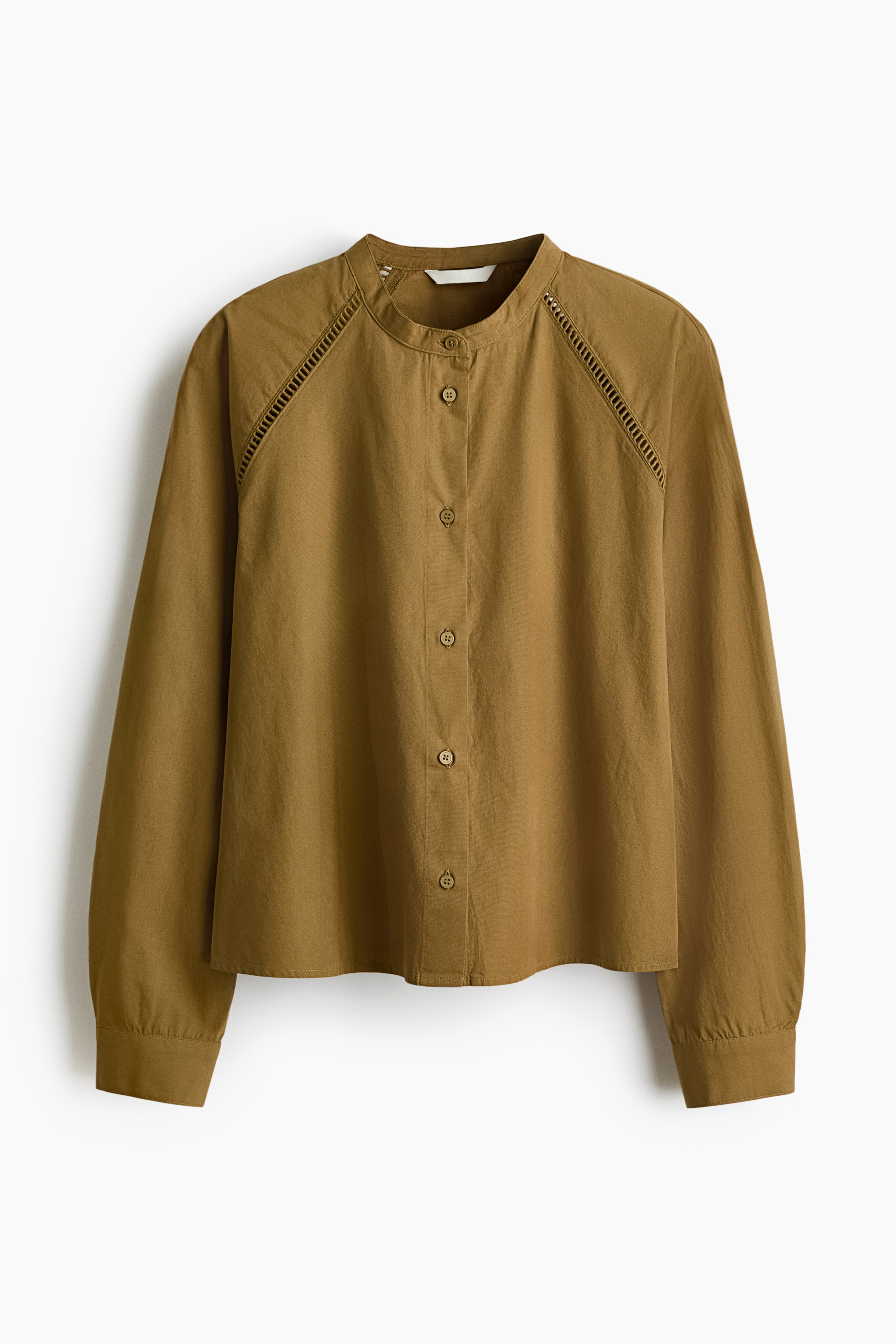 View larger image: The olive green blouse features a band collar with a full-button front placket. It showcases intricate eyelet detailing along the shoulder seams and long sleeves with buttoned cuffs.