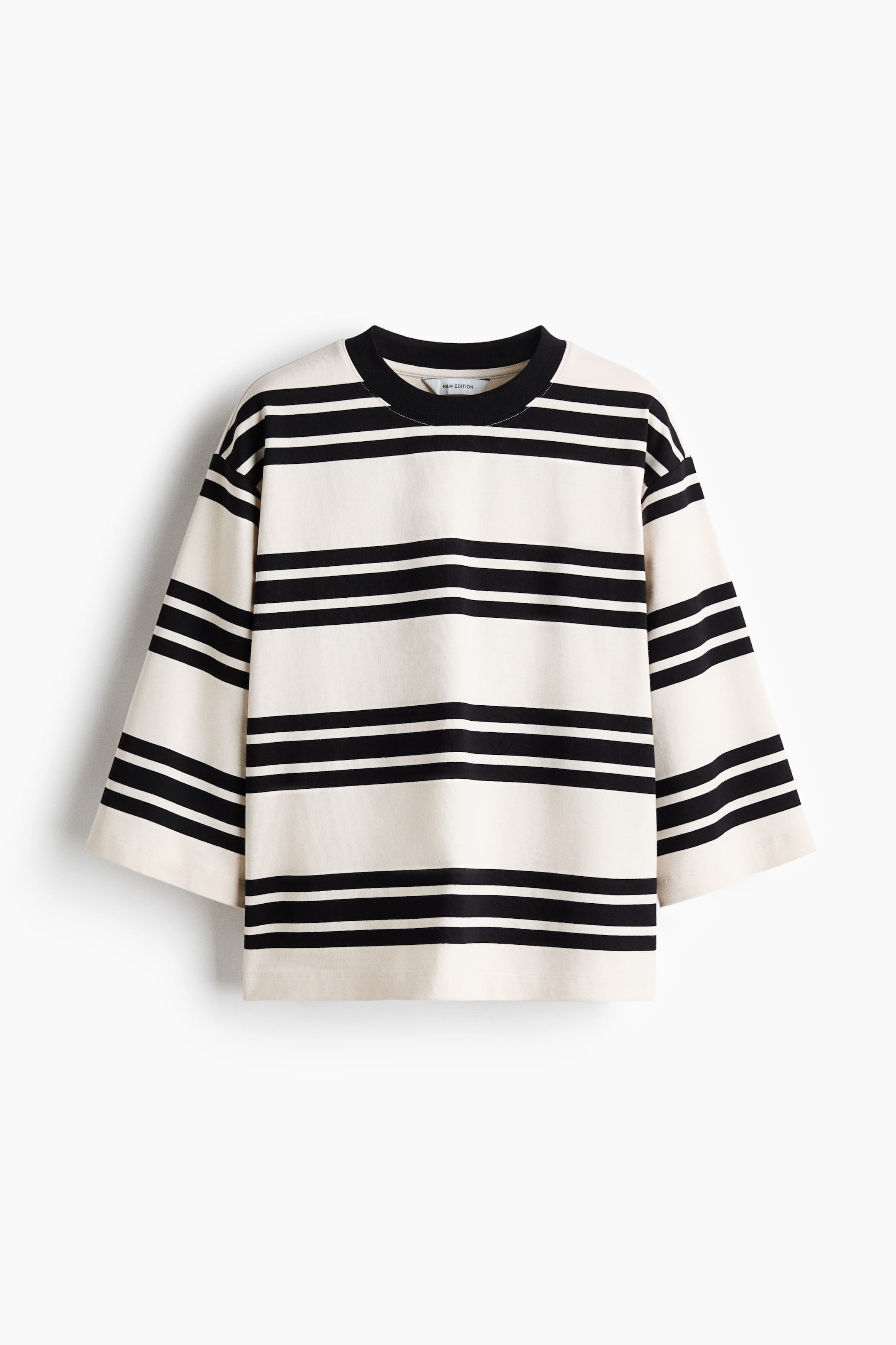 View larger image: A FRONT view of a loose-fit top in heavyweight cotton jersey is showing cream and black horizontal stripes. It is featuring a black rib-trimmed crew neckline, dropped shoulders, and wide, 3/4-length sleeves.