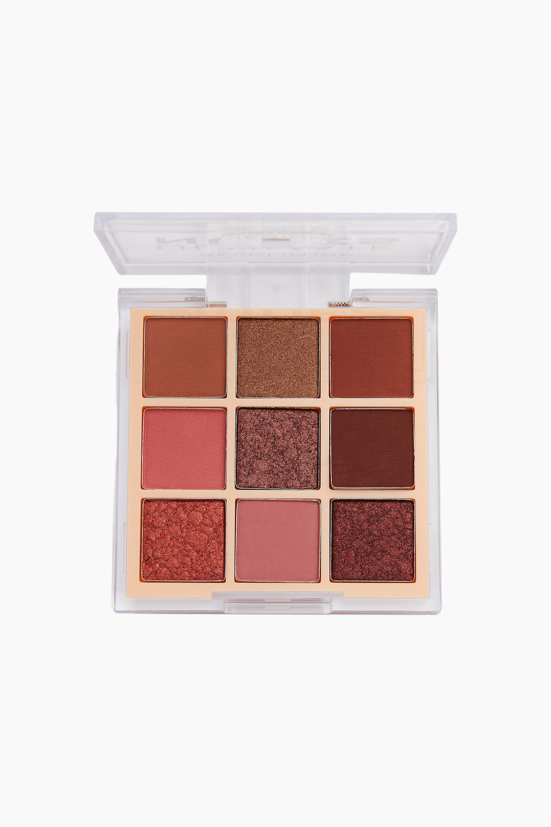 Größeres Bild ansehen: Die Revolution Ultimate Nude Shadow Palette liegt geöffnet in einer frontal ausgerichteten Ansicht und zeigt neun quadratische Lidschattenpfännchen, die in einem Drei-zu-Drei-Raster angeordnet sind. Die Auswahl umfasst eine Mischung aus matten und metallisch schimmernden Finishes in warmen Braun-, Altrosa- und tiefen Burgundertönen, untergebracht in einem transparenten Kunststoffetui.