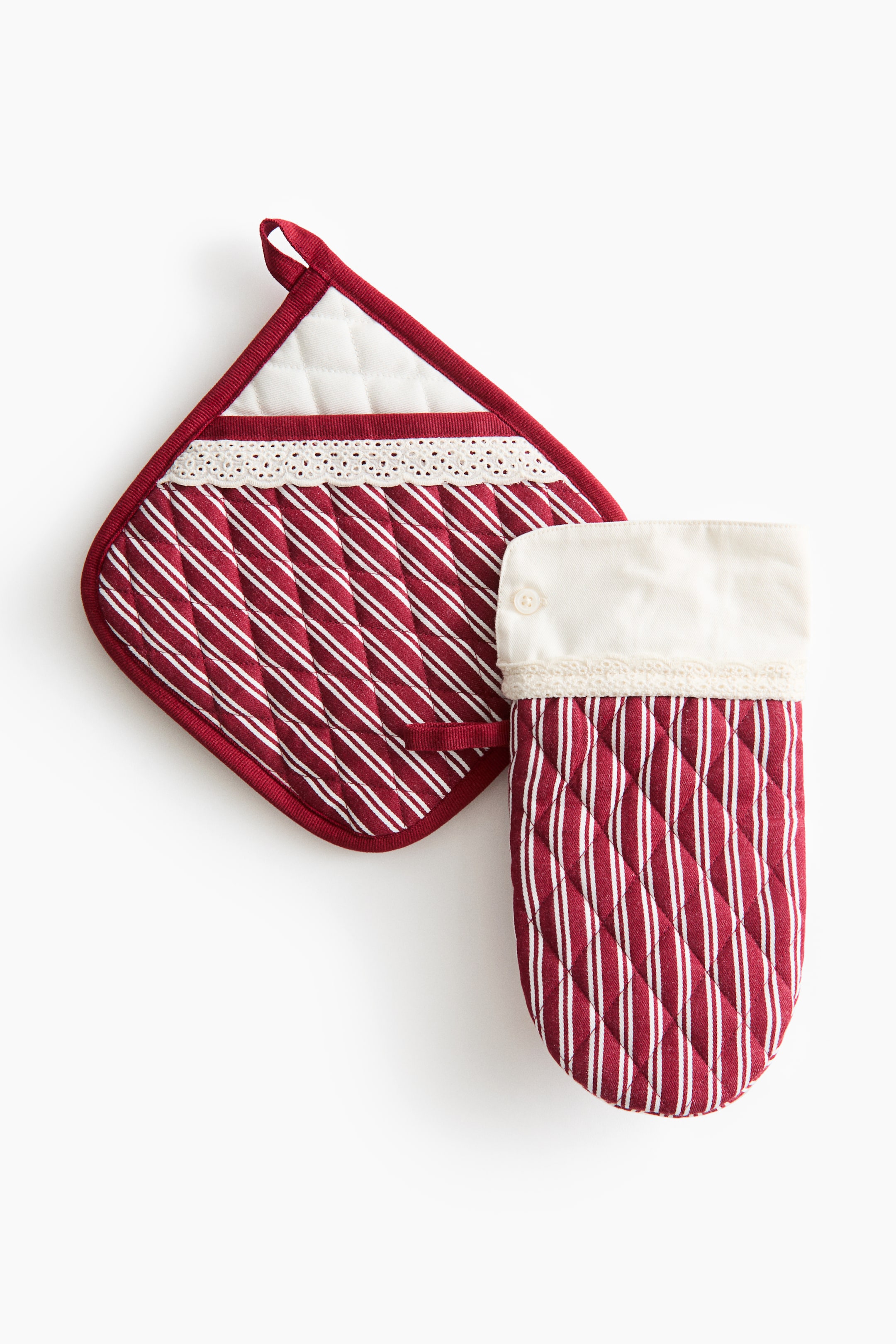 View larger image: A kitchen linen set comprising a quilted pot holder and an oven mitt showcases a red and white striped design. The pot holder features a white quilted pocket with delicate lace trim and a hanging loop, while the matching oven mitt displays a folded white cuff with a small button.