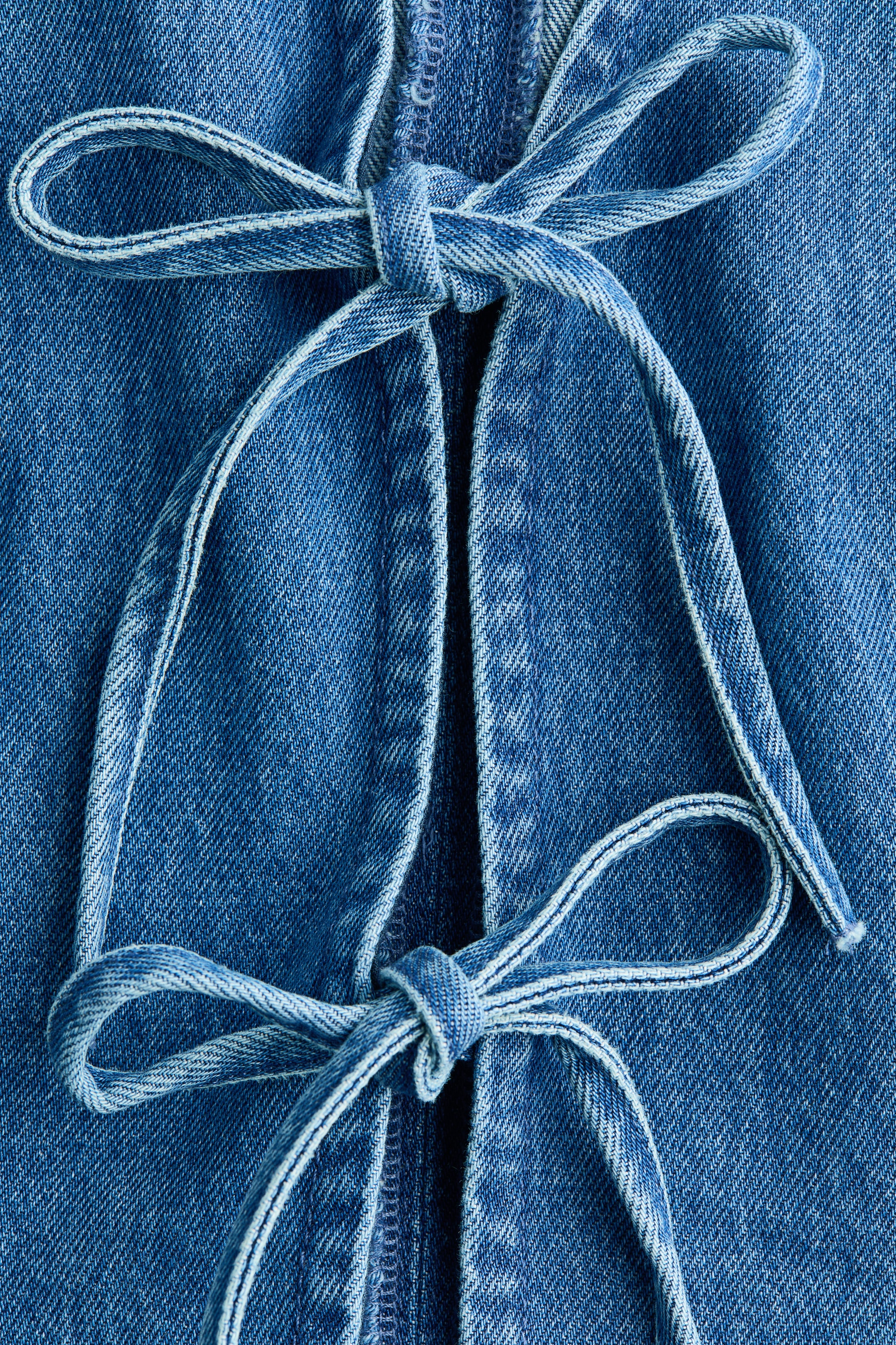 Gilet sans manches en denim avec liens à nouer