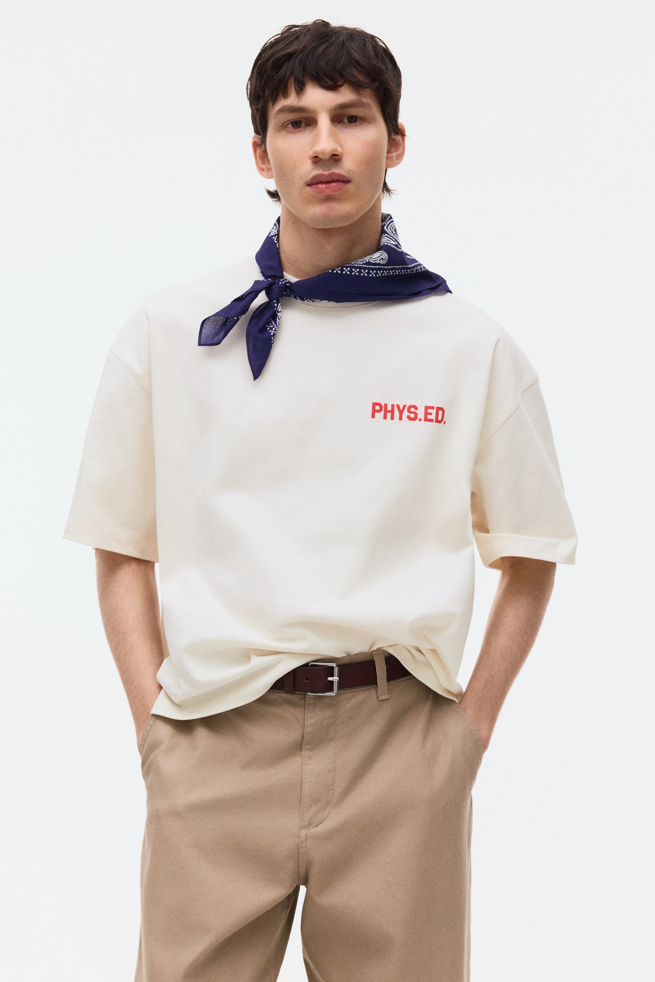 View larger image: The cream t-shirt comes with a round neck, a relaxed fit, and short sleeves. The front chest showcases the red 'PHYS.ED.' text, and the short sleeves are styled with rolled-up cuffs.