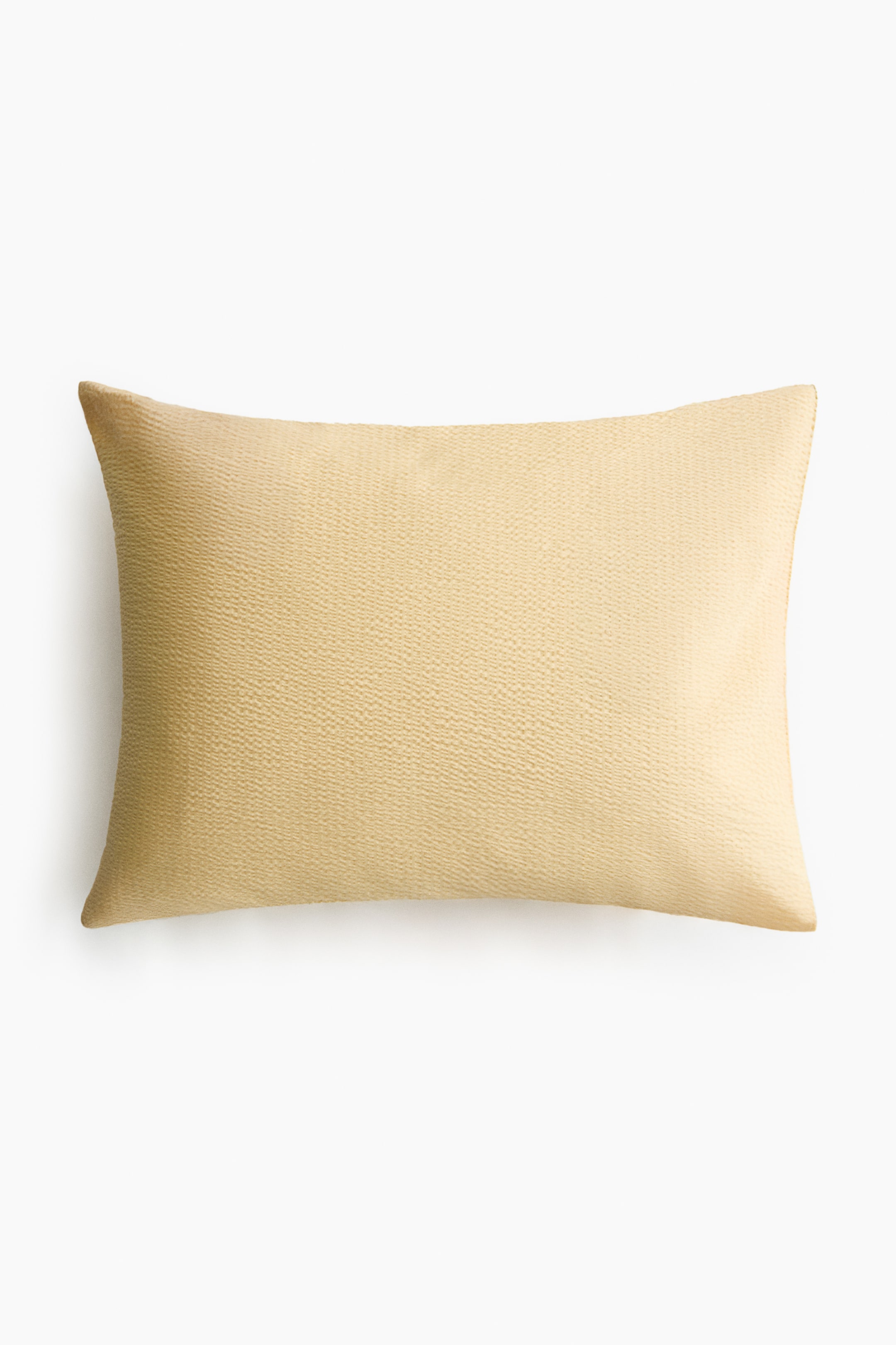 View larger image: A rectangular pillowcase is lying flat, presenting its FRONT view. It is made of light beige seersucker fabric, displaying its characteristic puckered texture.