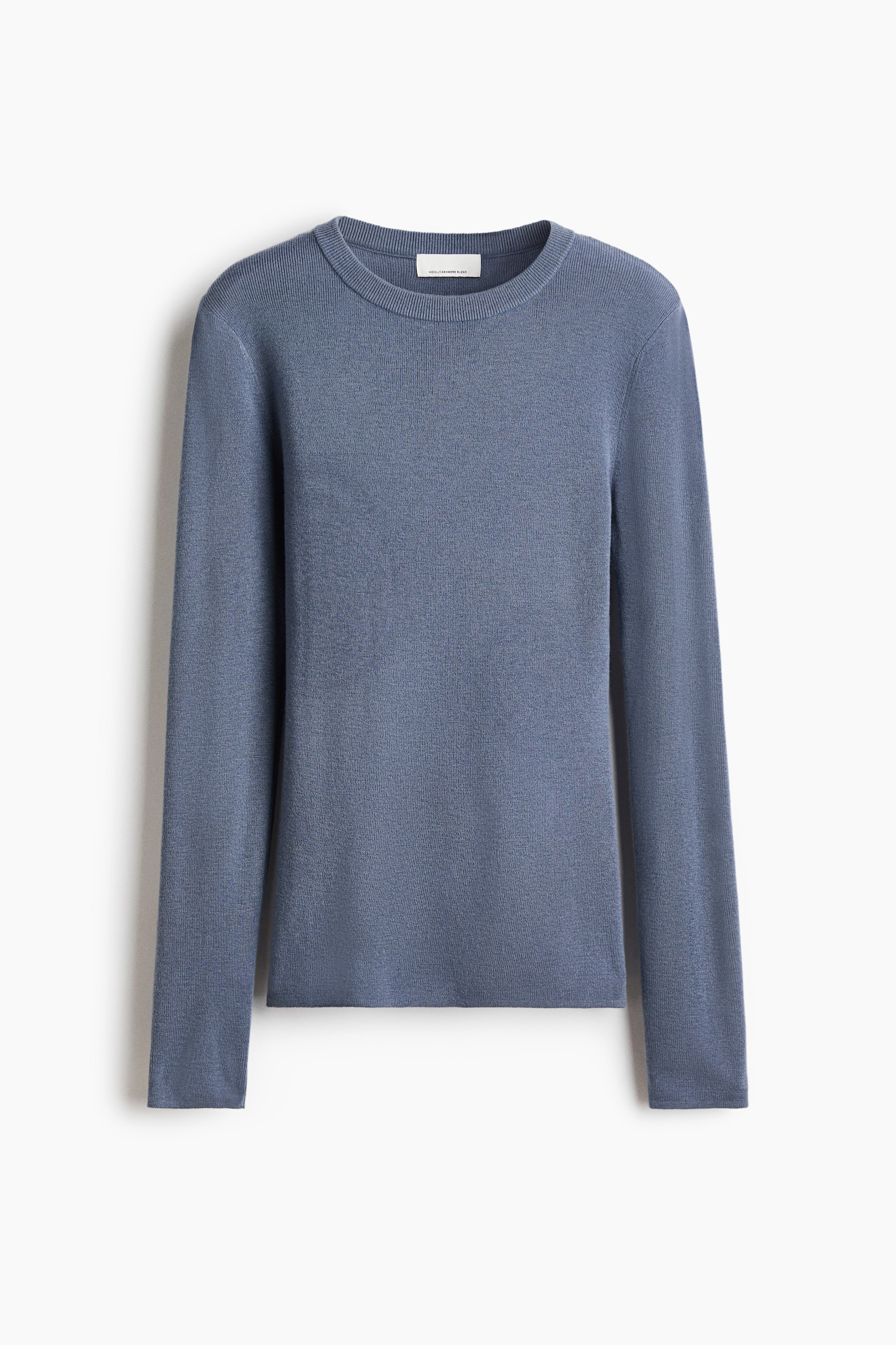 View larger image: A fine-knit, muted blue wool-blend top is shown from the front, showcasing a fitted silhouette, a round ribbed neckline, and long straight sleeves.
