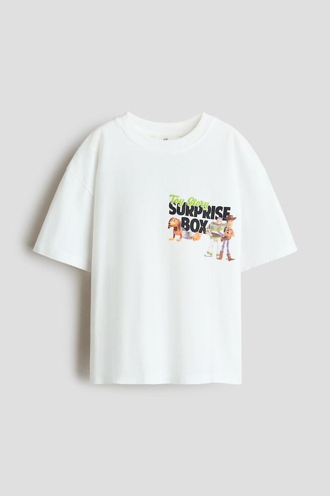 Playera Loose-fit con diseño - Blanco/Toy Story/Crema/Mickey Mouse/Rojo claro/Spidey/Blanco/Hot Wheels/Rojo/Marvel Comics/Crema/Snoopy/Gris jaspeado claro/Spider-Man/Gris/Spider-Man/Gris oscuro/CapyFun - 1