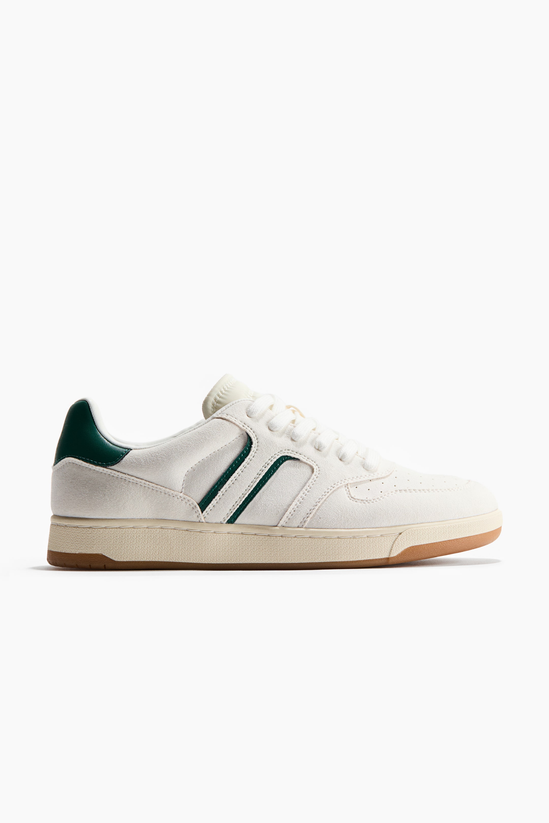 View larger image: The sneaker features an off-white suede upper, complemented by a dark green heel tab and two parallel dark green stripes along the side. It showcases off-white laces, perforations on the toe box, an off-white midsole, and a brown rubber outsole.