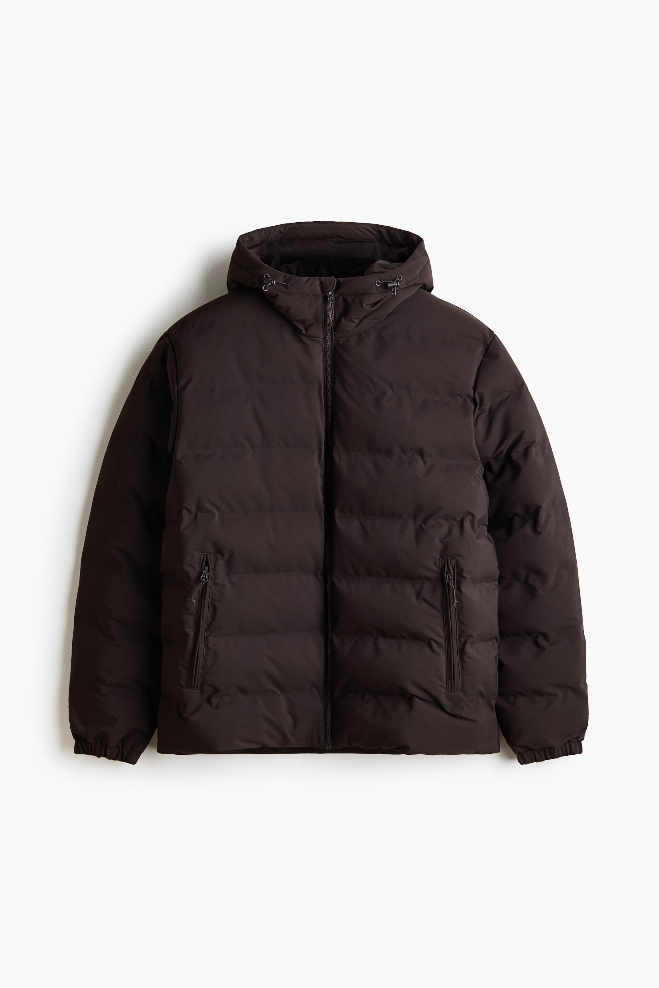 View larger image: A dark brown puffer jacket is shown from the front, featuring an attached hood with adjustable drawstrings and toggles, a full-length front zip, and two vertical zip pockets. The jacket also features elasticated cuffs and a subtly textured, horizontally quilted design.