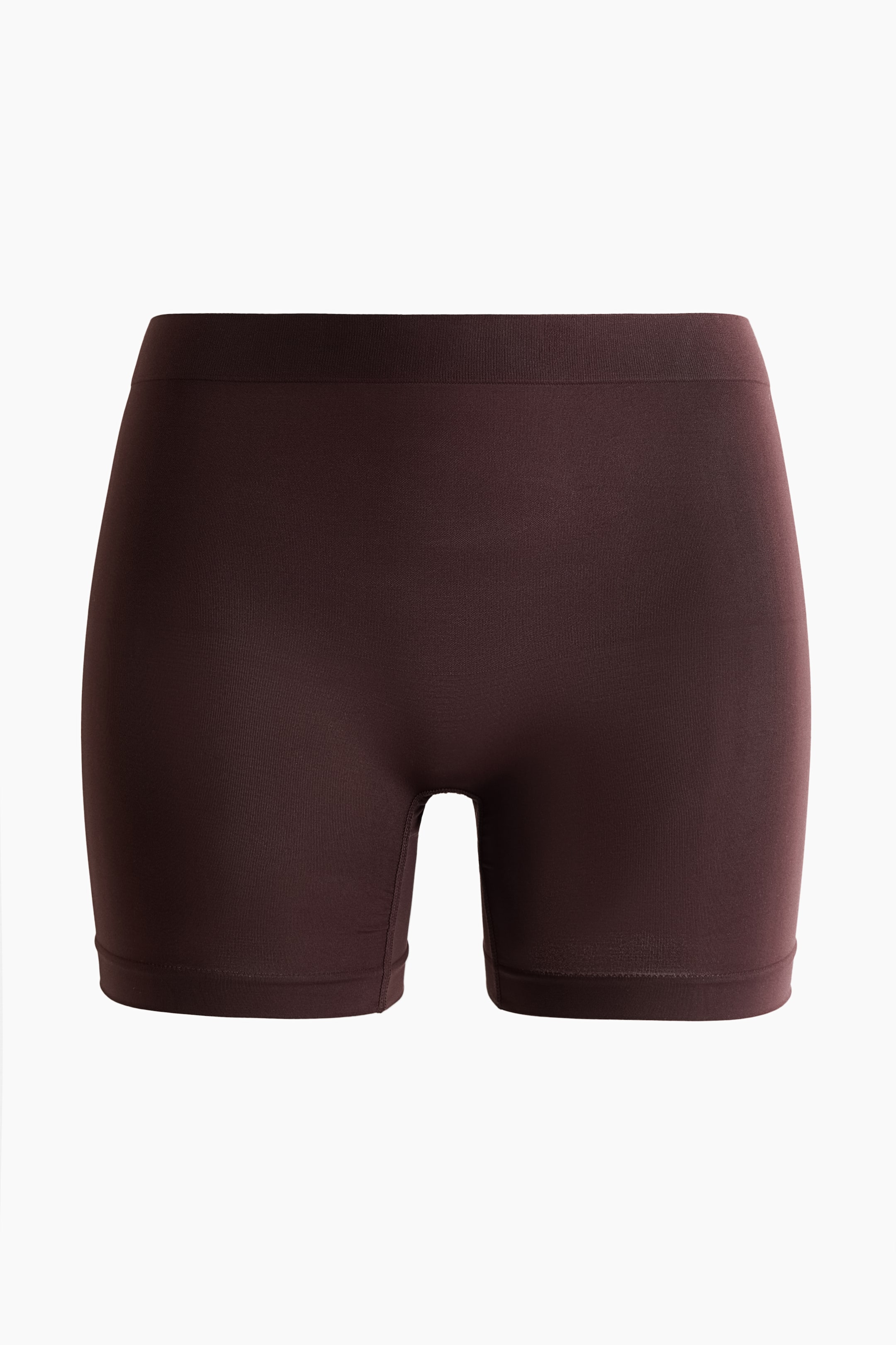 View larger image: The dark brown high-waisted bikers boast a sleek, seamless design at the front, showcasing wider, reinforced edges at the waist and mid-thigh leg openings.
