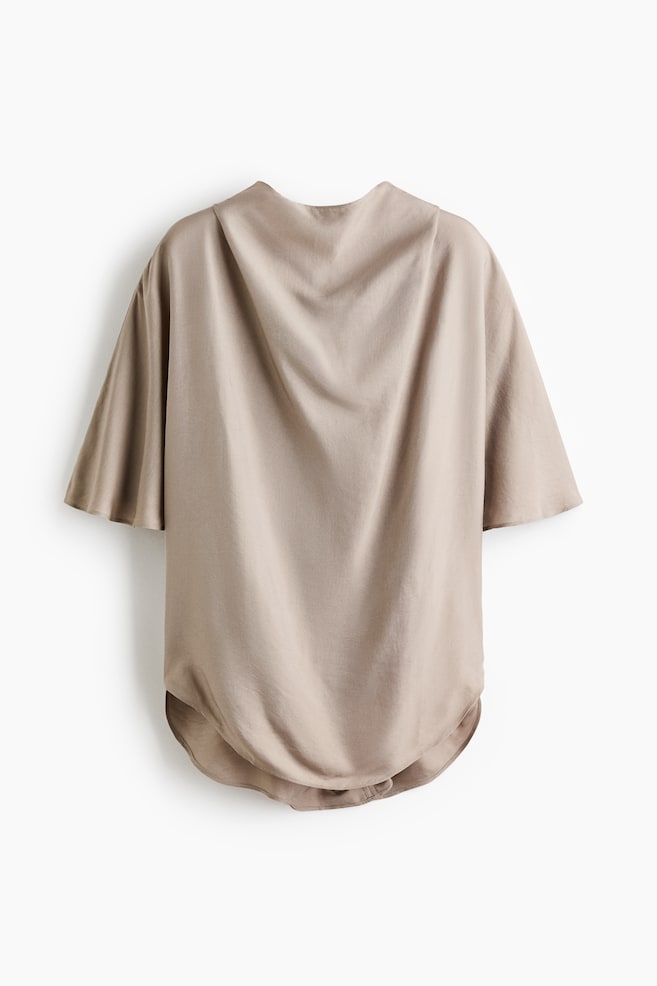 A taupe loose-fitting top is showcasing its back, featuring a draped neckline, wide short sleeves, and a rounded hem. - 1