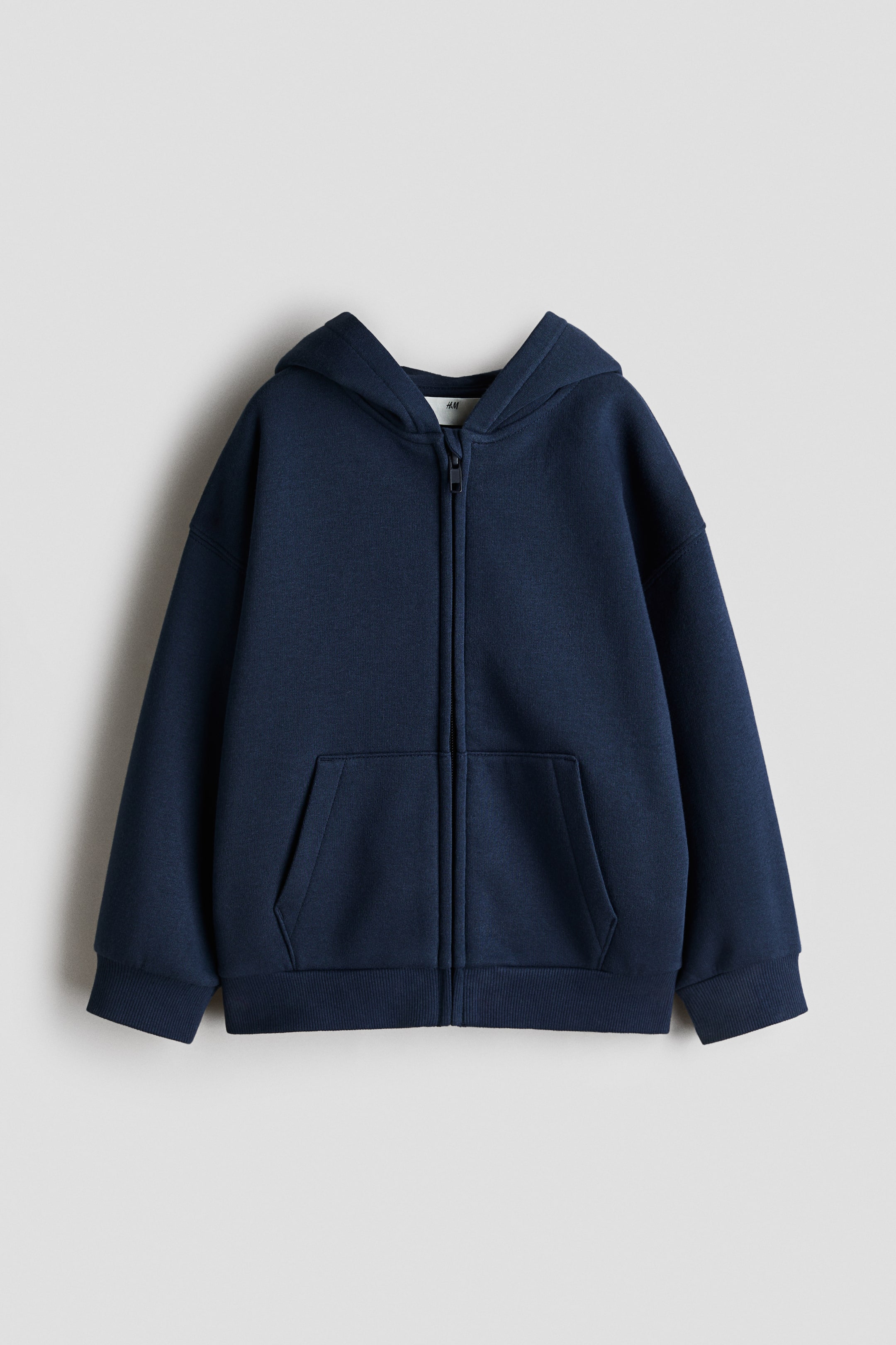 View larger image: A navy blue zip-up hoodie is showcased from the front, highlighting its attached hood, full-length zipper, spacious kangaroo pocket, and ribbed cuffs and hem.