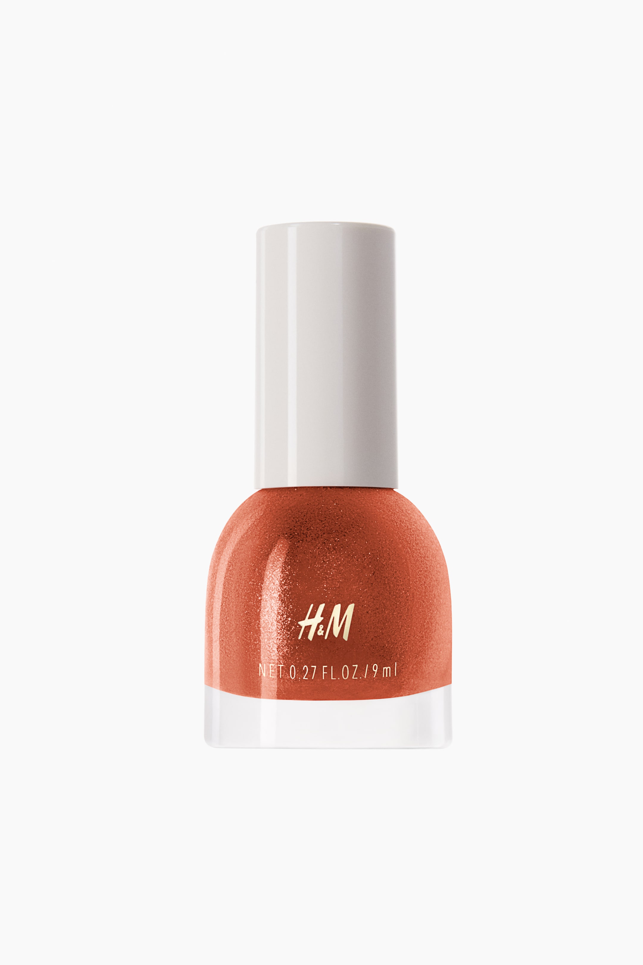View larger image: The nail polish bottle showcases a lustrous orange-copper hue, with a rounded transparent glass base and a white cap. The "H&M" logo along with the net volume is prominently displayed on the front of the bottle.