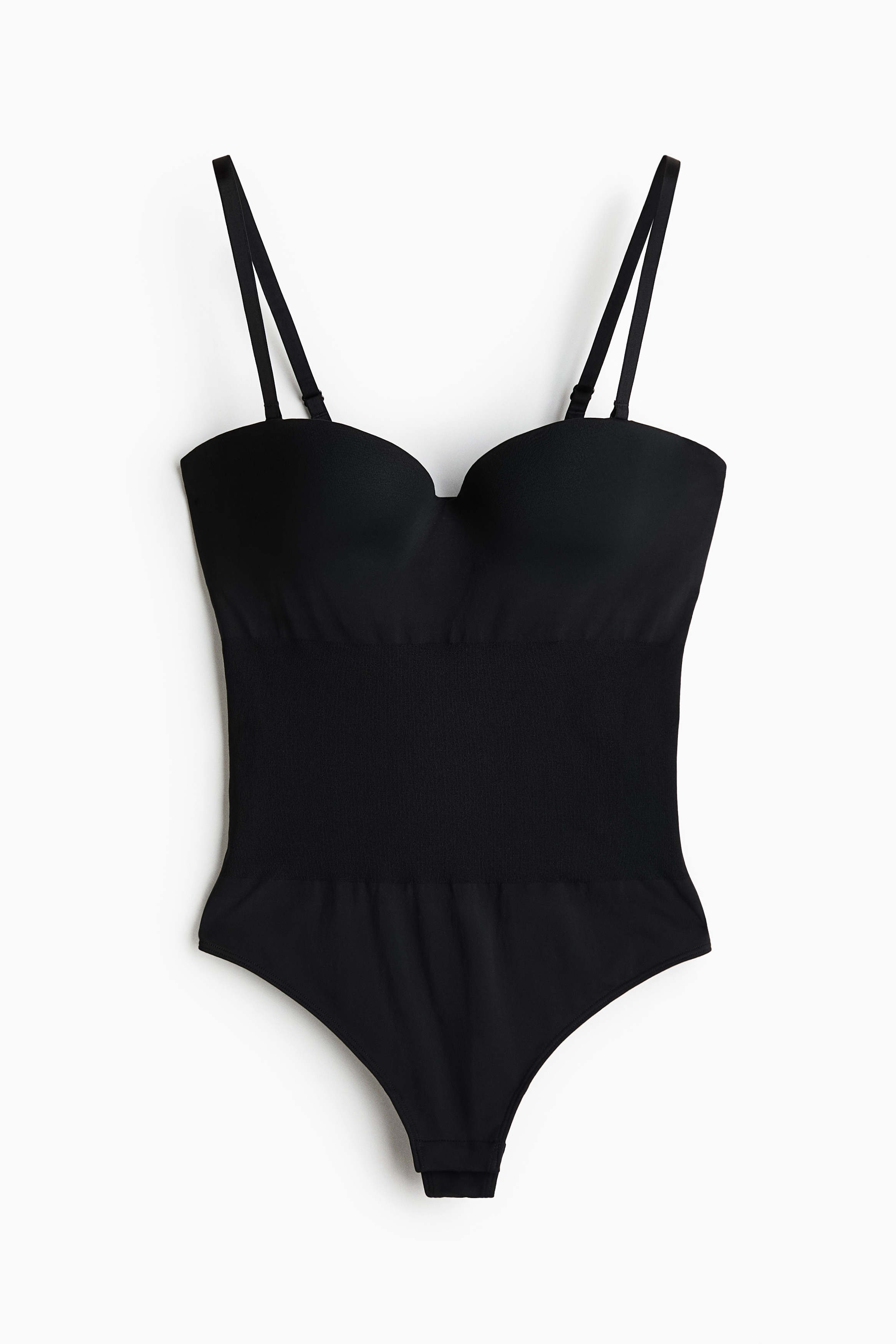 A black strapless bodysuit with moulded cups and a sweetheart neckline is being worn by the model. The form-fitting shapewear features a smooth, seamless design that contours the body.