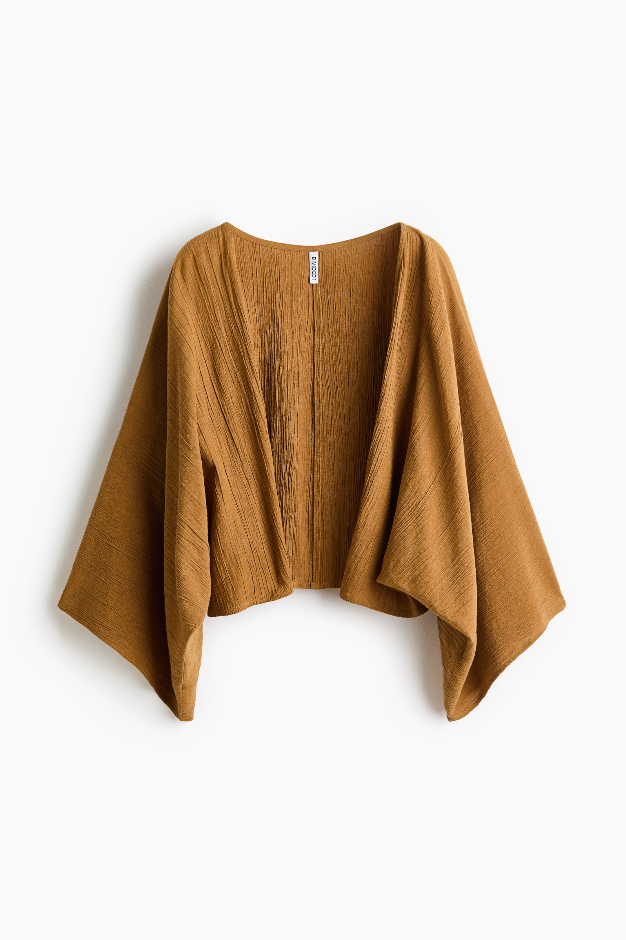 View larger image: Shown from the front, a brown-orange, crinkled kimono-style top with an open front and wide, flowing sleeves. It features a cropped, irregular hemline and a visible brand tag at the back of the neck.