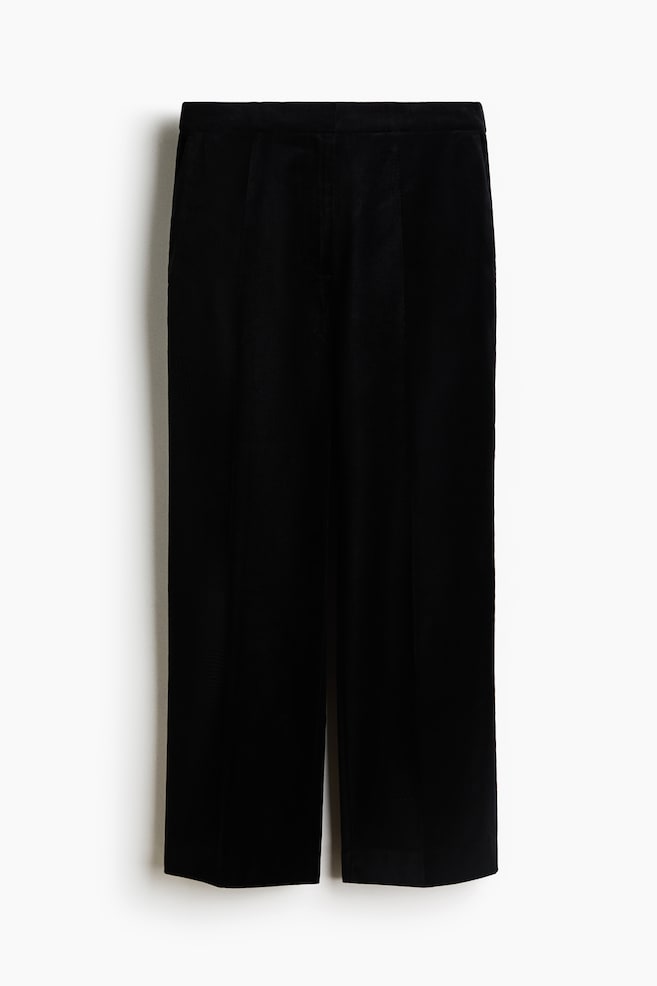 Black woven pants are facing the front, featuring a high waist and a clean front closure. The straight legs are displaying subtle pressed creases down the center. - 1