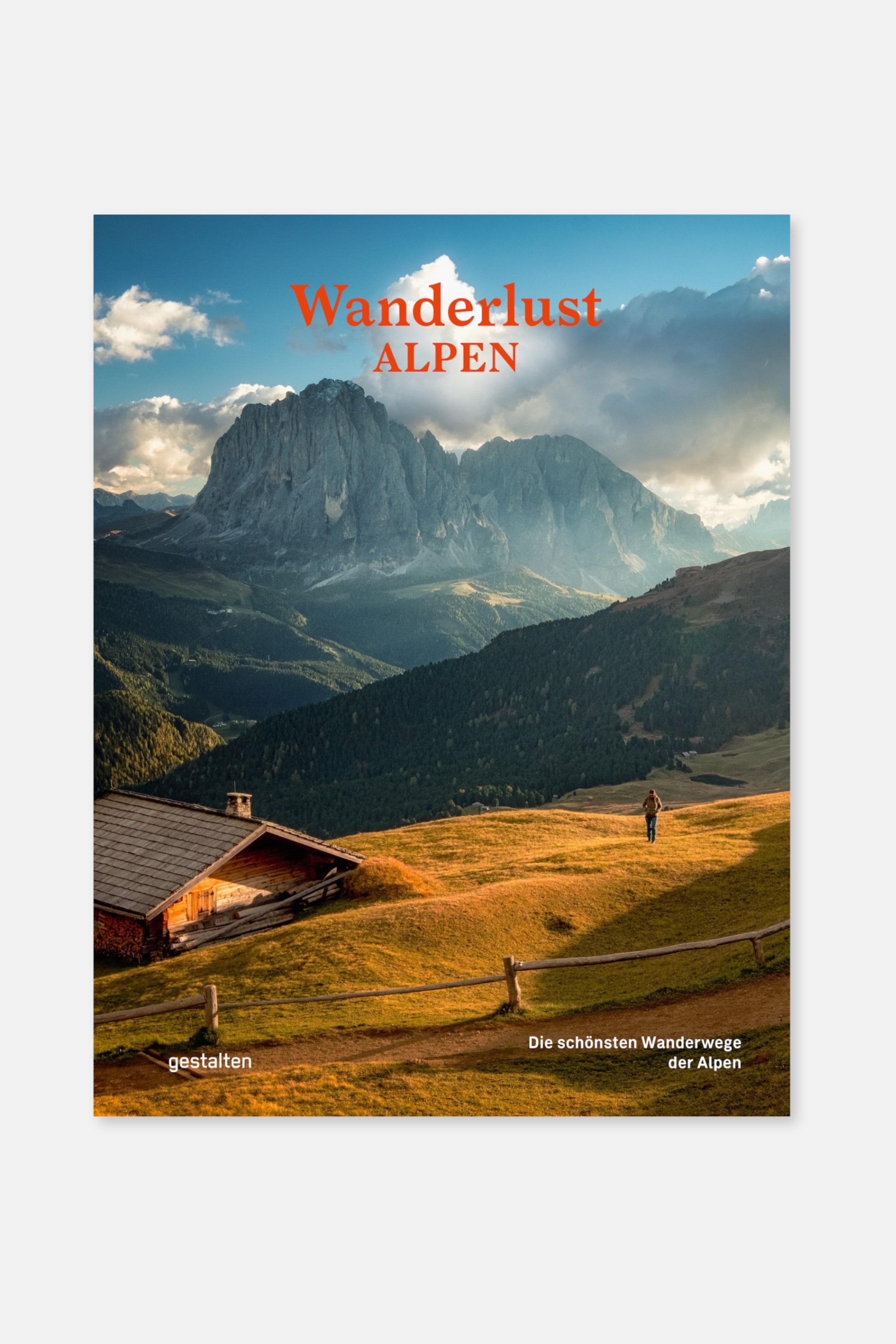 Größeres Bild anzeigen: Das Buch zeigt seine Vorderseite, auf der ein Landschaftsfoto einer Bergkette, einer Holzhütte und einer Person, die durch ein grasbewachsenes Feld geht, zu sehen ist. Der Titel "Wanderlust ALPEN" ist in orangefarbener Schrift oben sichtbar, während "gestalten" und "Die schönsten Wanderwege der Alpen" in weißer Schrift unten erscheinen.