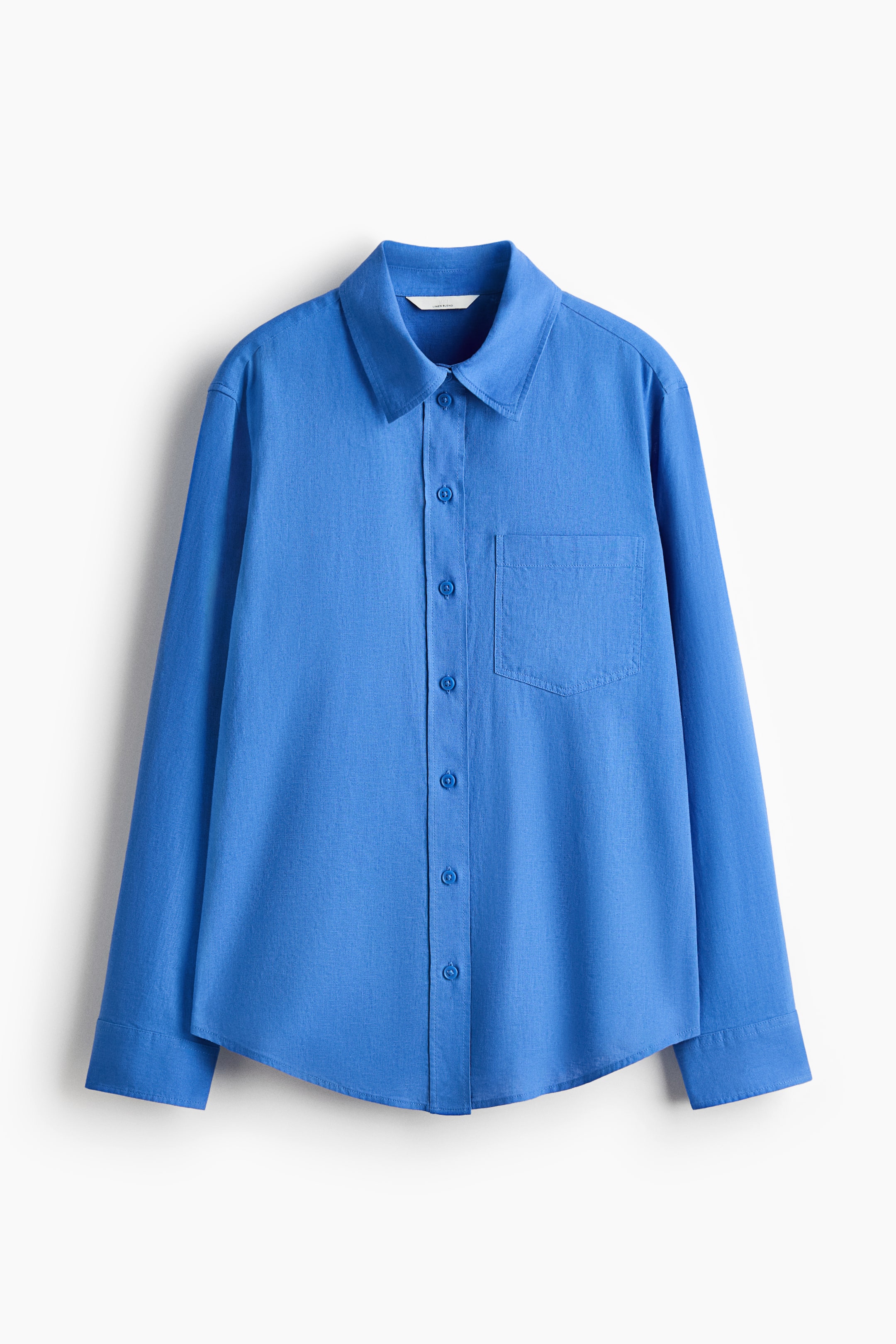 View larger image: A loose-fit blue shirt featuring an airy, textured weave, a collar, and a full button-front closure. An open chest pocket is visible on the left, and it presents long sleeves with buttoned cuffs and a curved hem.