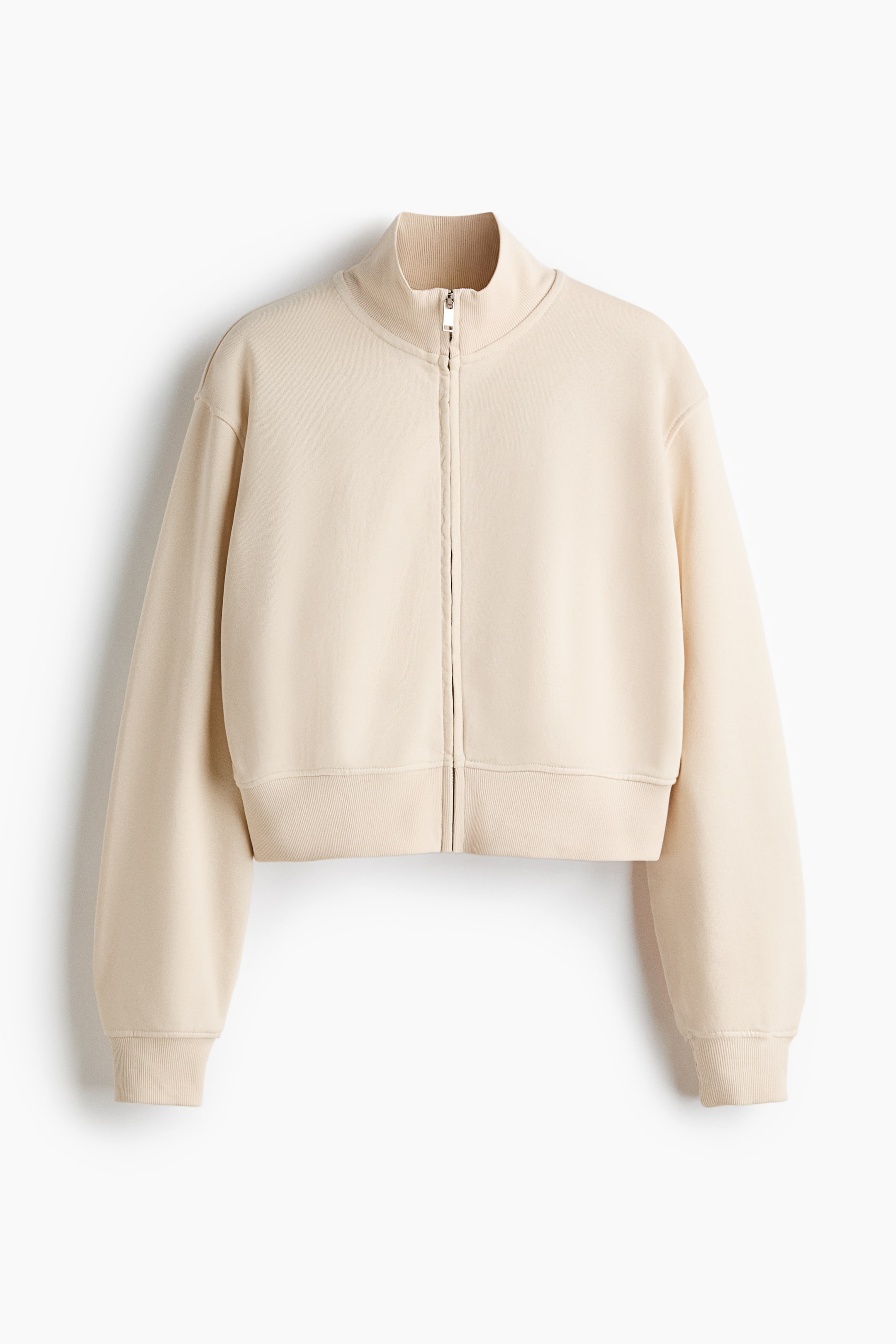 View larger image: A beige cropped sweatshirt is presenting FRONT, featuring a full-length zipper closure, a ribbed stand-up collar, ribbed cuffs, and a ribbed hem.