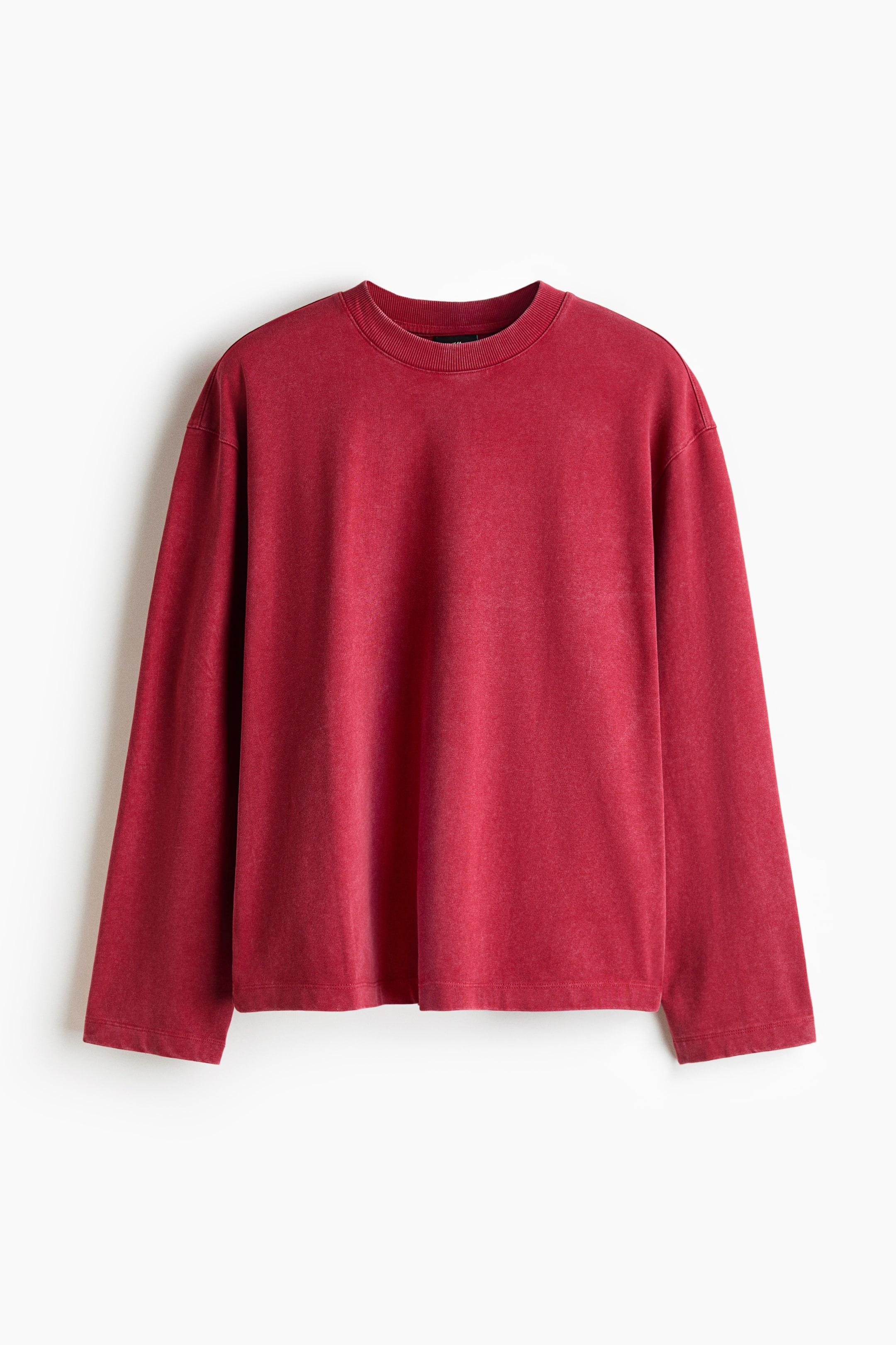 View larger image: A red long-sleeved top is displayed front-facing, showcasing a ribbed crew neck, a faded, washed-out look, long sleeves, and a straight hemline.