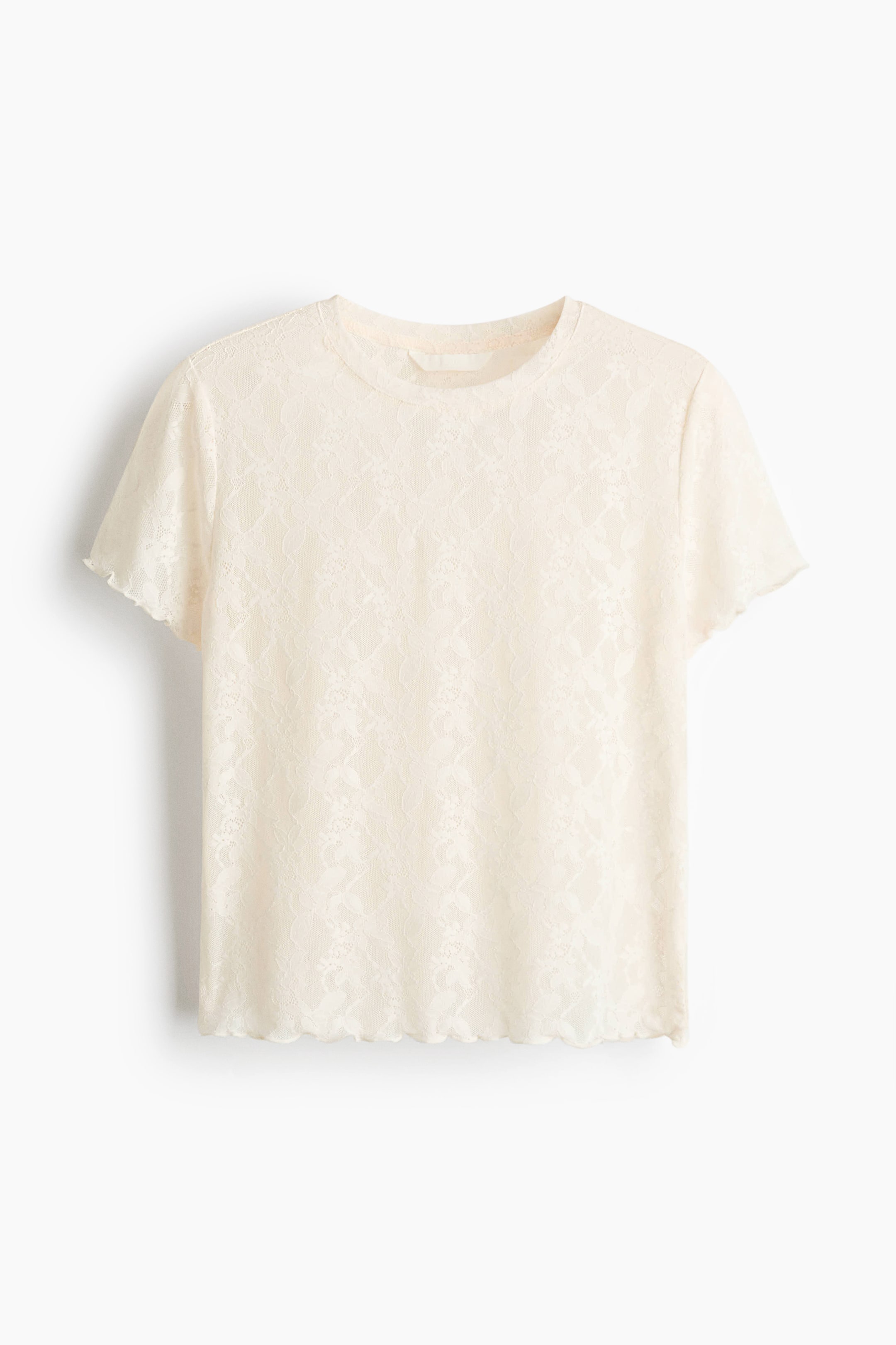 拡大画像を表示: クリーム色のフィットしたTシャツは、ラウンドネックライン、ショートスリーブ、袖口と裾のオーバーロック仕上げが特徴です。ストレッチレースで作られており、繊細な花柄が施されています。