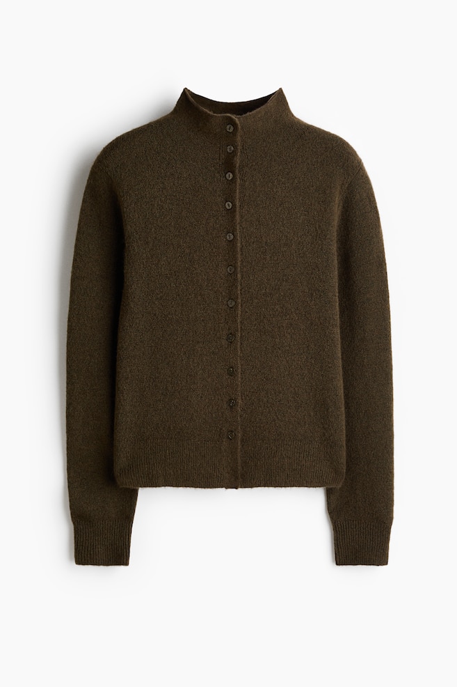 A dark olive green cardigan is presented front-facing, featuring a fuzzy texture and a mock neck. It is showing a full button-front closure with matching dark buttons, long sleeves with ribbed cuffs, and a ribbed hem. - 1
