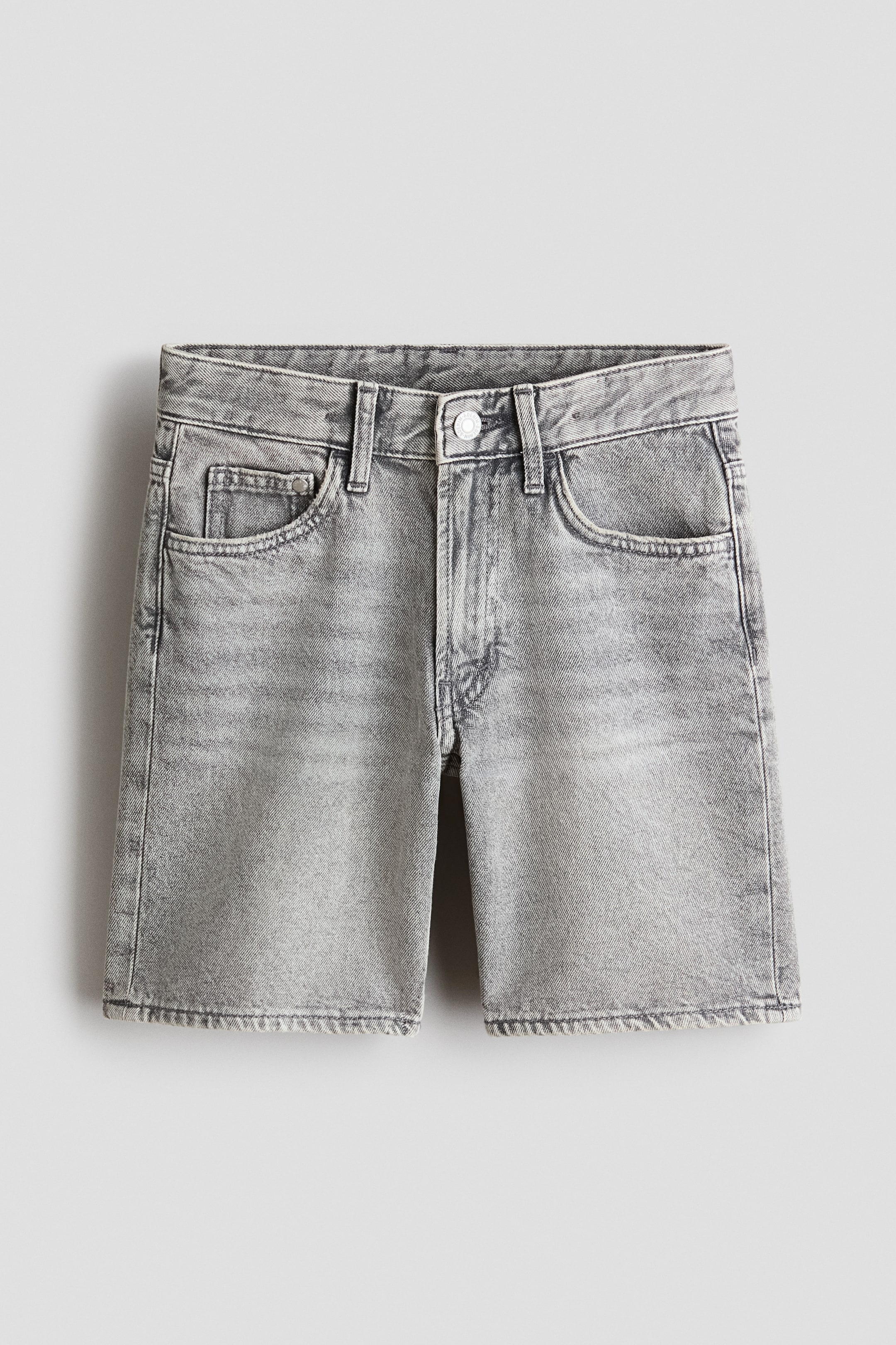 View larger image: Washed grey denim shorts are shown from the front, featuring a 5-pocket style, a loose fit through the hip and thigh, and a zip fly with a button closure at the waist.