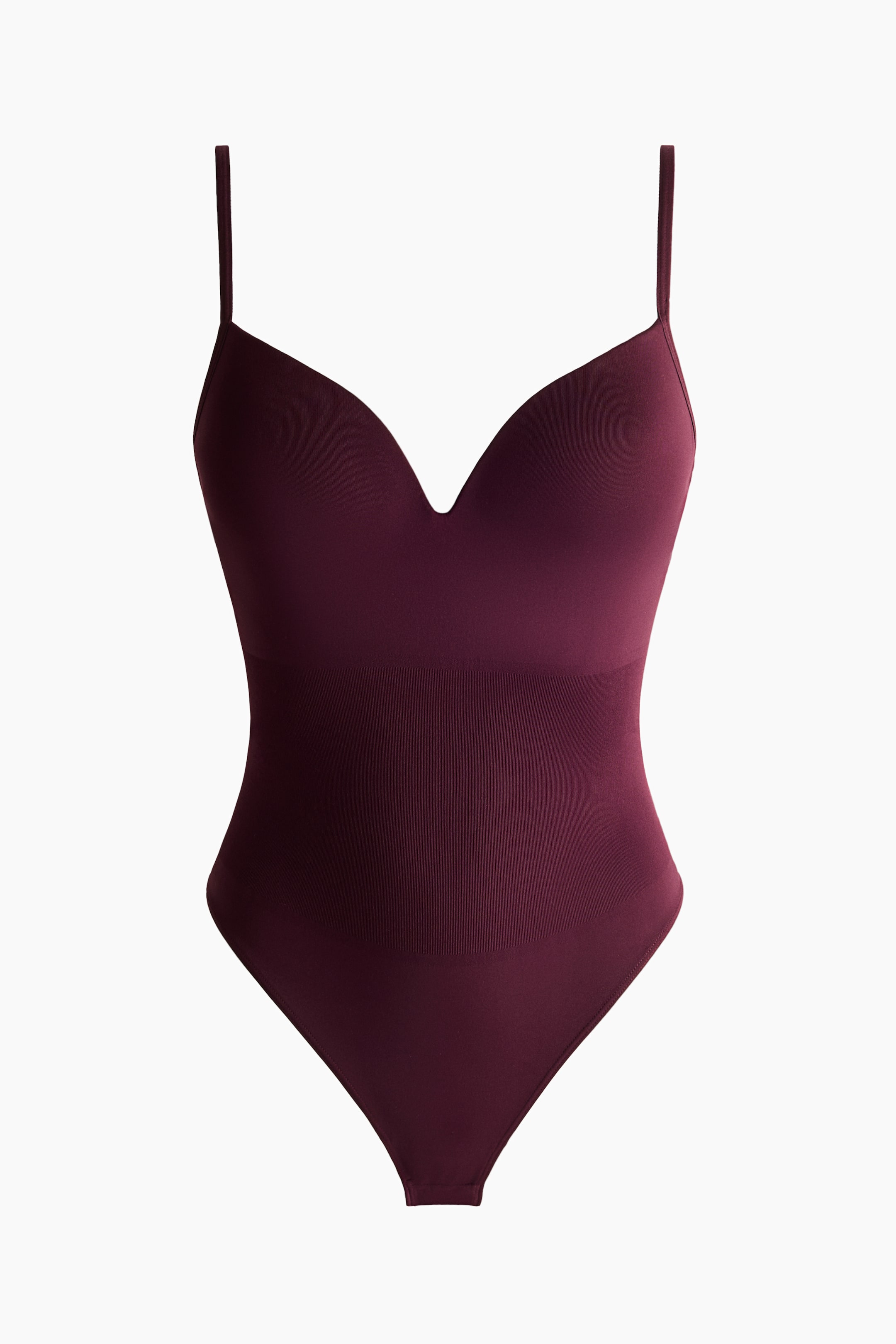 View larger image: A burgundy bodysuit showcases a deep V-neckline, slender spaghetti straps, and a sleek, form-fitting design with a subtle, fine-knit texture on the torso.