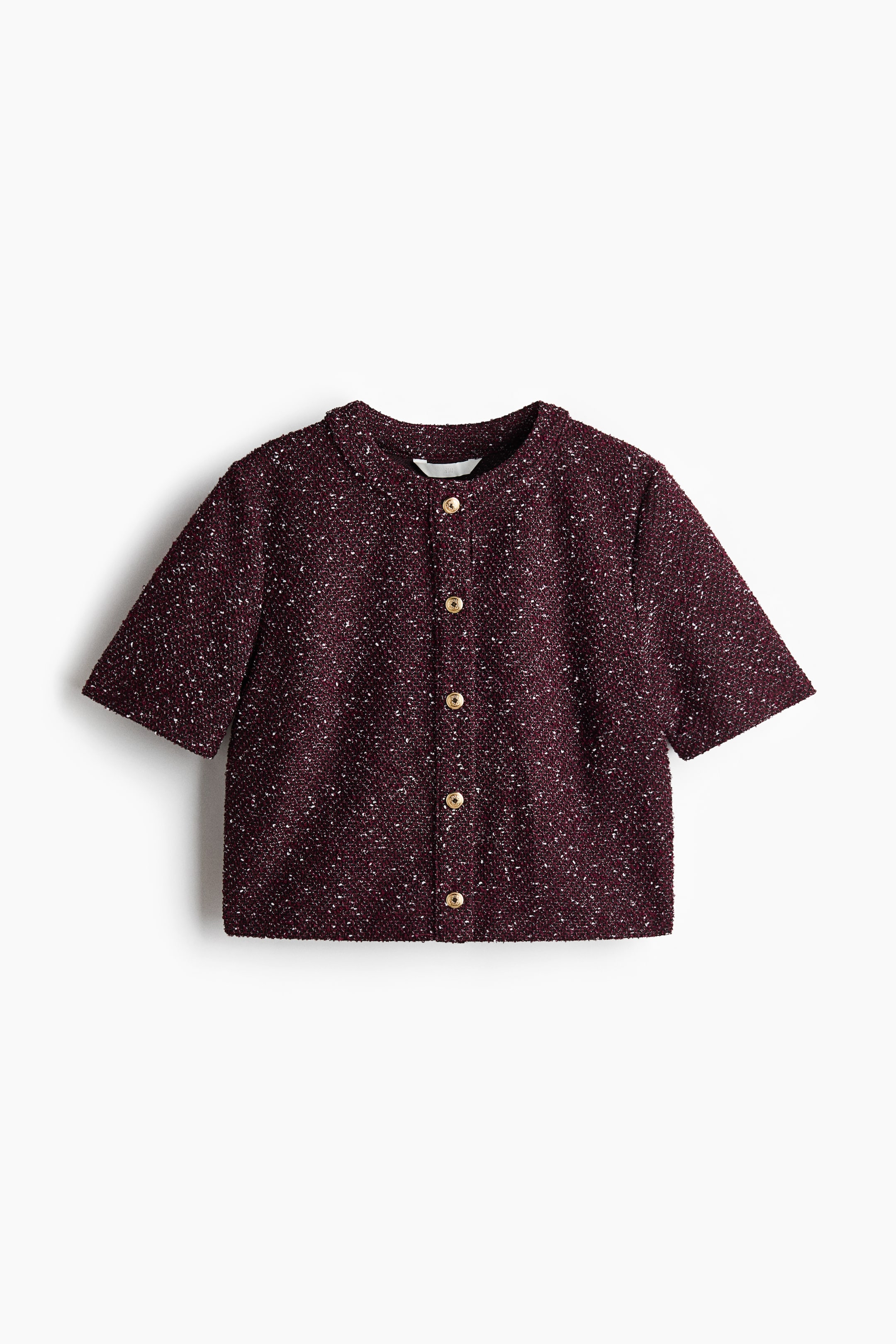 View larger image: A short-sleeved jacket is shown from the front, featuring dark red and white speckled tweed fabric. It is designed with a round neckline and a front button closure, accented by six gold-tone buttons.