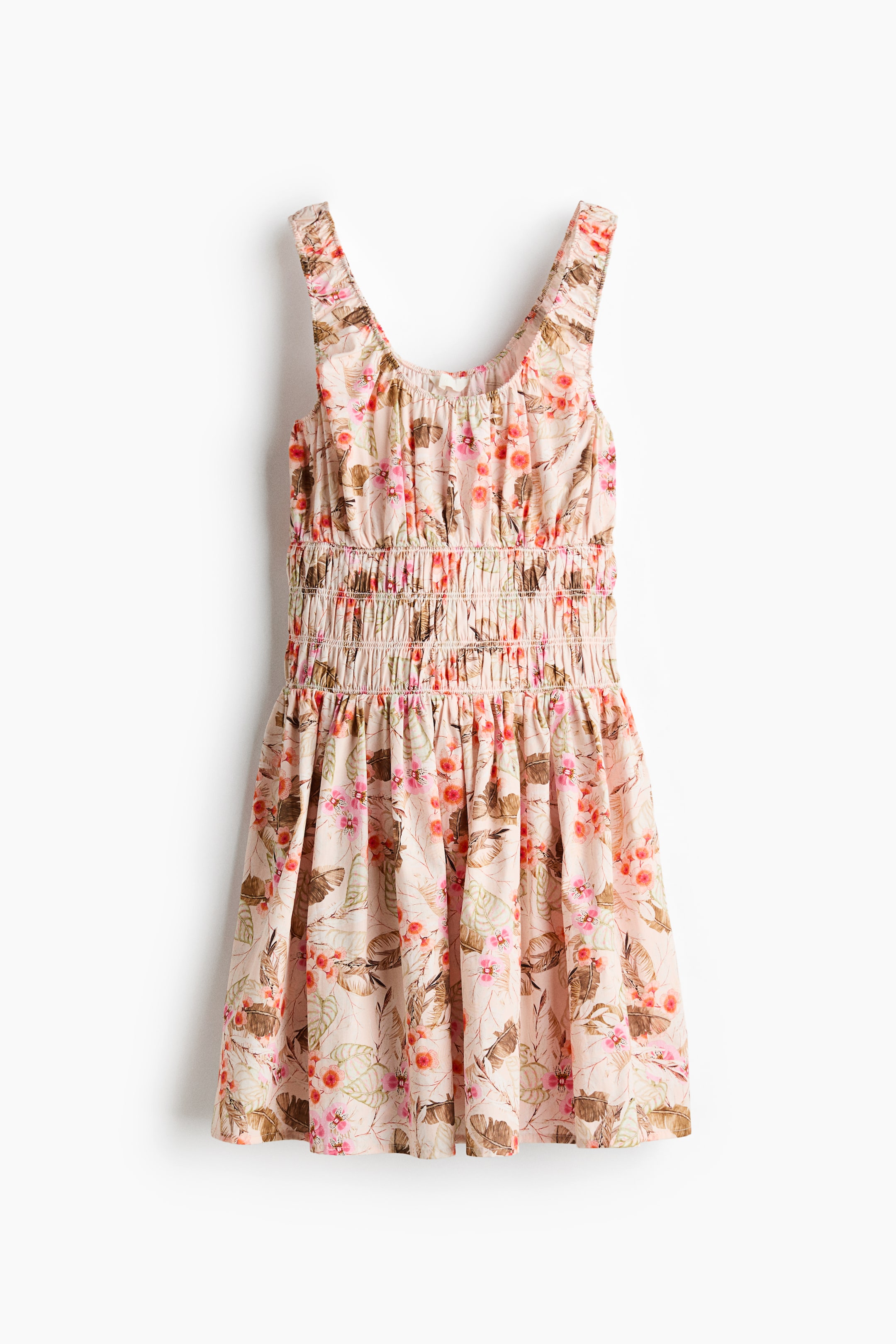 View larger image: Dress, front. This sleeveless light-pink dress features a scoop neckline, a shirred waist with multiple rows of gathering, and a flared skirt, all adorned with a pattern of brown leaves and pink and orange flowers.