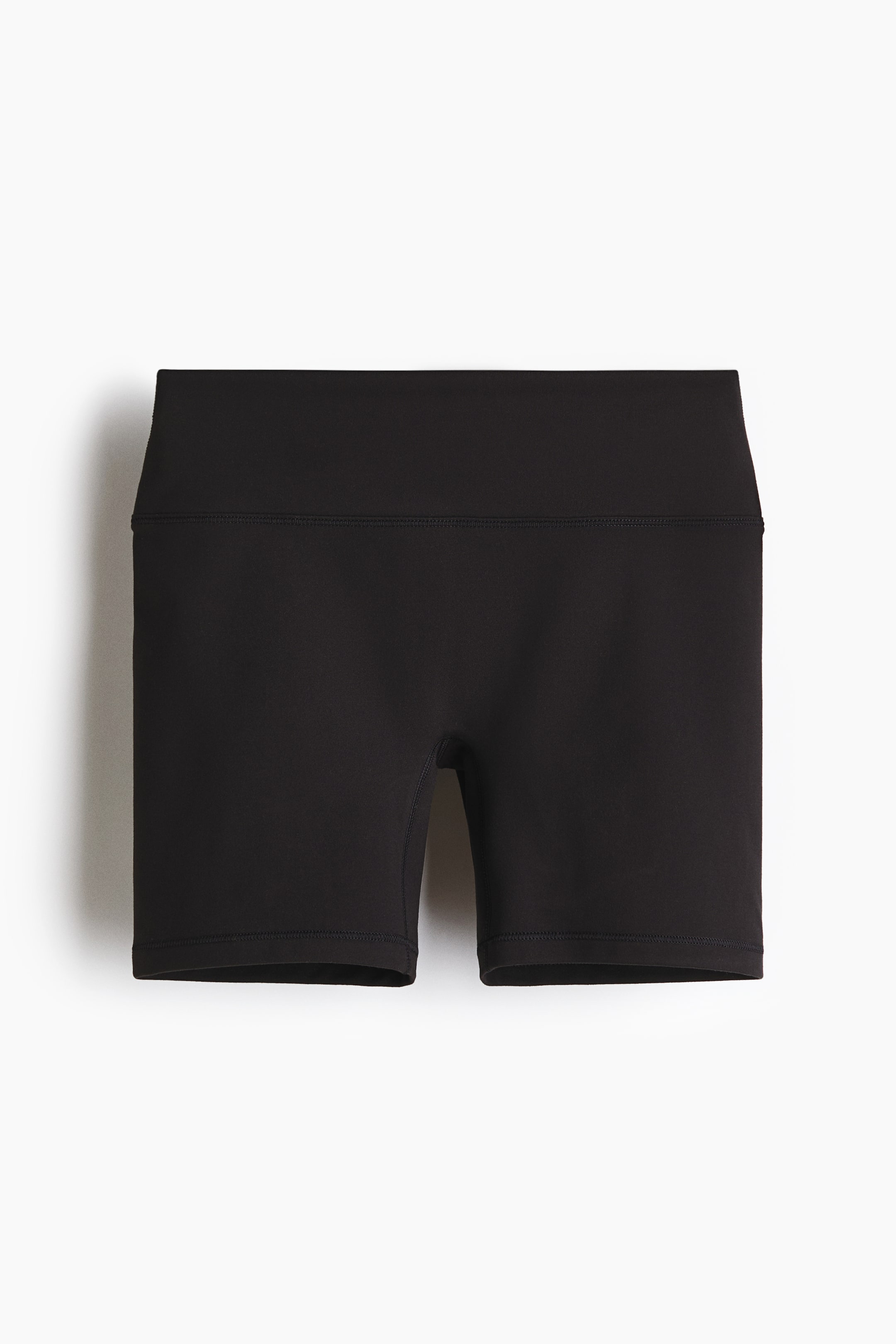 View larger image: Black shorts shown from the front, featuring a wide, high-rise waistband. The form-fitting shorts extend to mid-thigh, with visible stitching on the leg hems.