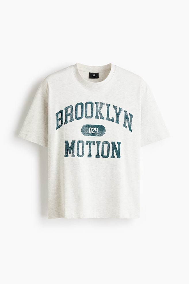 A heathered light grey T-shirt is presenting its front, featuring a round, rib-trimmed neckline, dropped shoulders, and a straight-cut hem. The front is displaying a distressed dark teal print with "BROOKLYN" arched above "024" and "MOTION". - 1