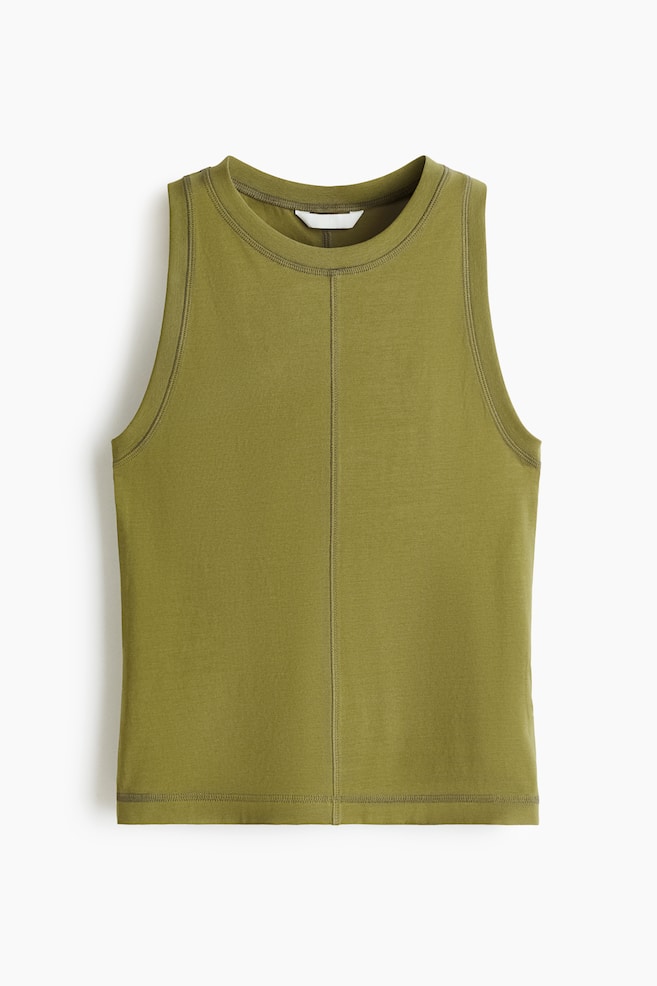 An olive green tank top is featuring a round neckline and a sleeveless design, presented from the front. A prominent vertical seam is running down the center front, and a white tag is visible inside the back neckline. - 1