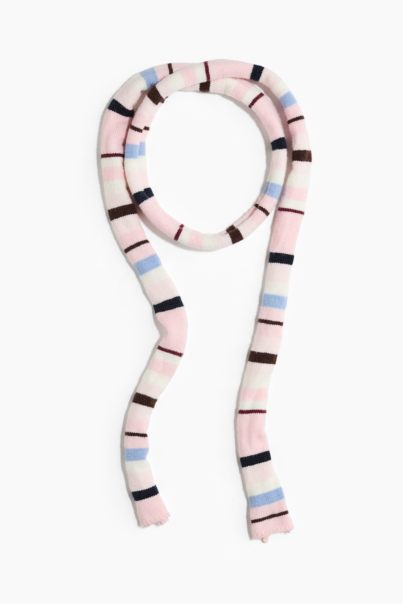 A long, narrow knit scarf is lying flat, featuring a horizontal stripe pattern in pink, white, light blue, navy blue, and brown. The scarf is arranged with a circular loop at the top and two long ends hanging downward.