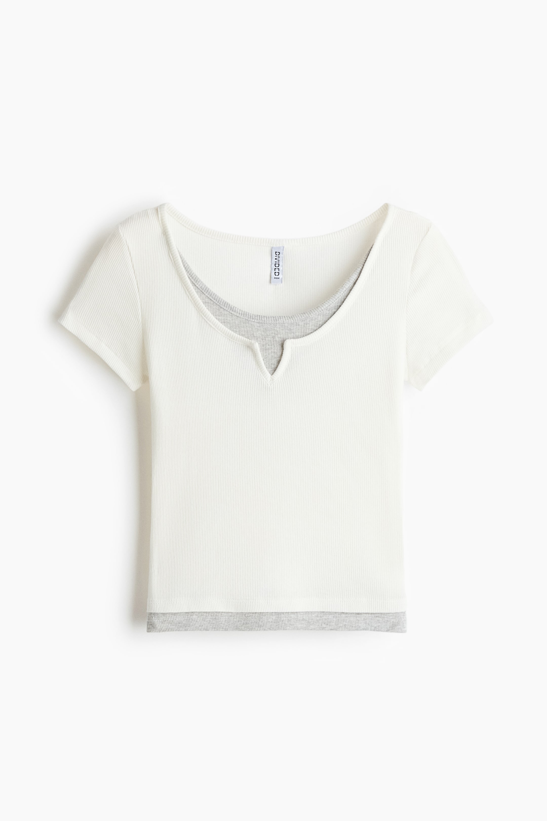 View larger image: A layered short-sleeved top is presenting a front view. An off-white ribbed top, with a wide, V-cut neckline, is layered over a grey ribbed underlayer that is visible at the neckline and at the hem.