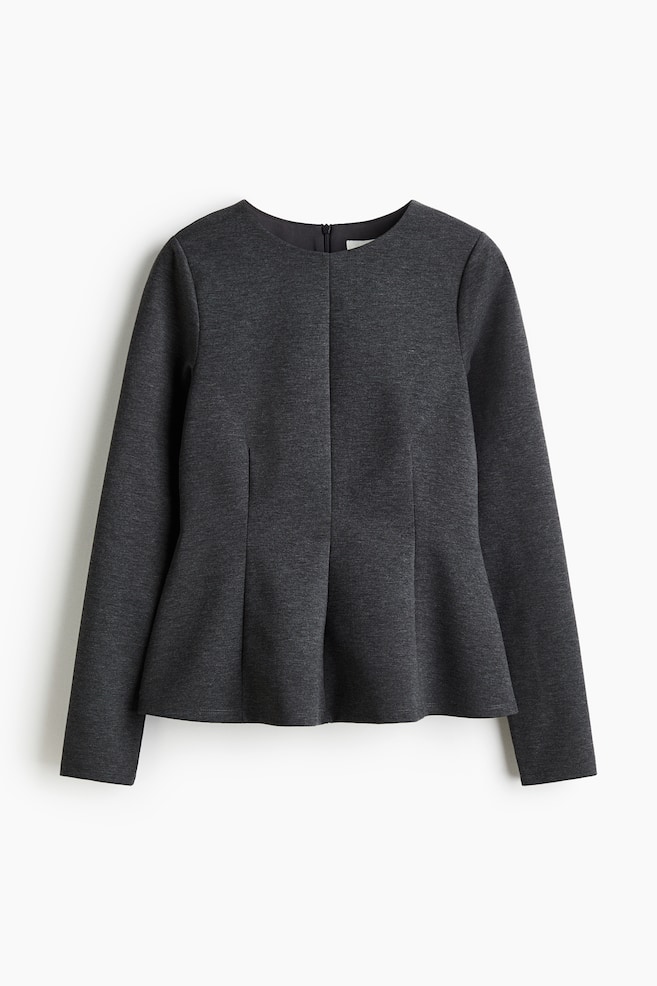 A dark grey peplum top is shown from the FRONT, featuring a round neck, long sleeves, and a short zipper visible at the back of the neck. Vertical seams are running down the front, creating a flared peplum hem. - 1