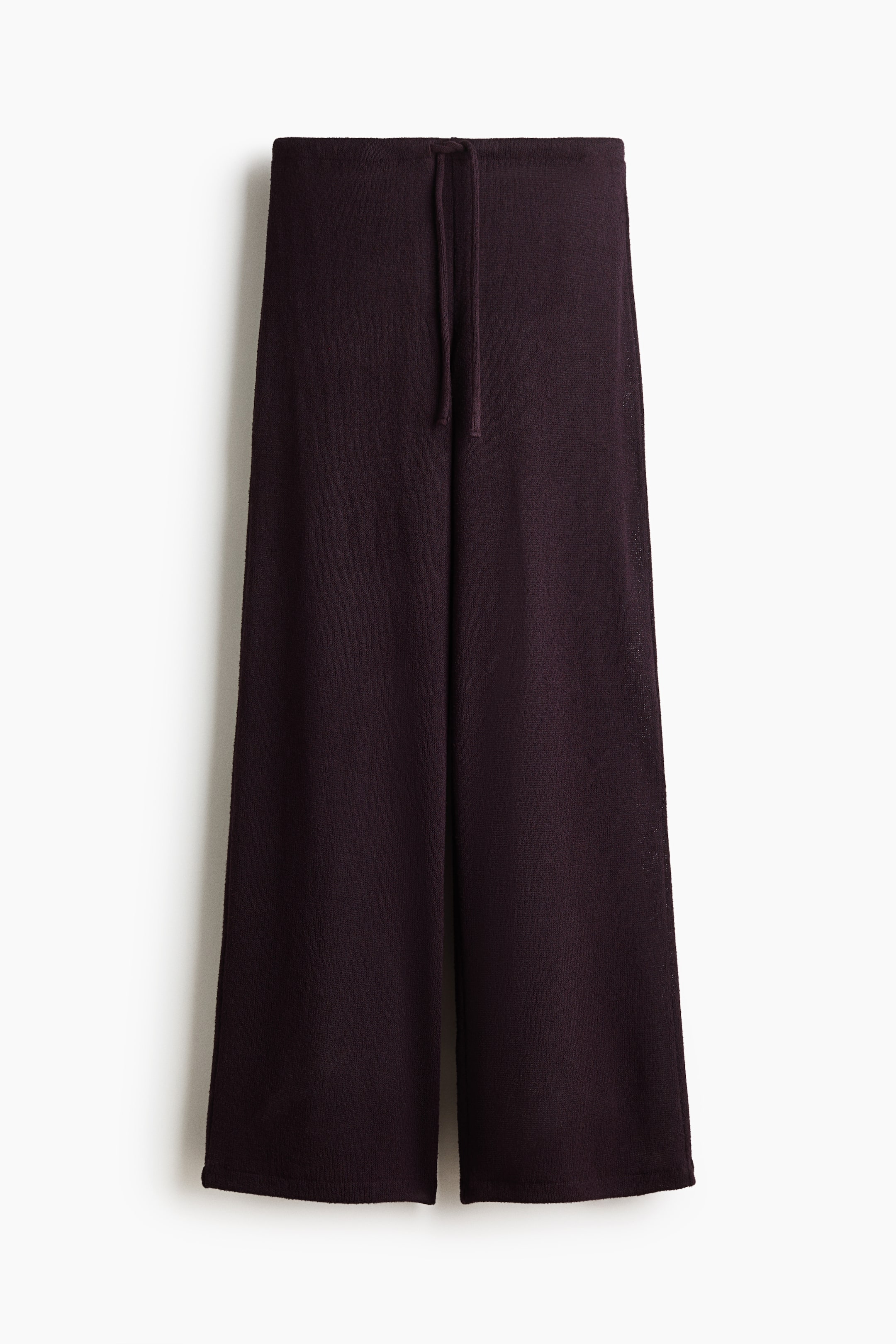 View larger image: A pair of dark plum knit wide-leg trousers showcases its front view, highlighting a drawstring waistband.