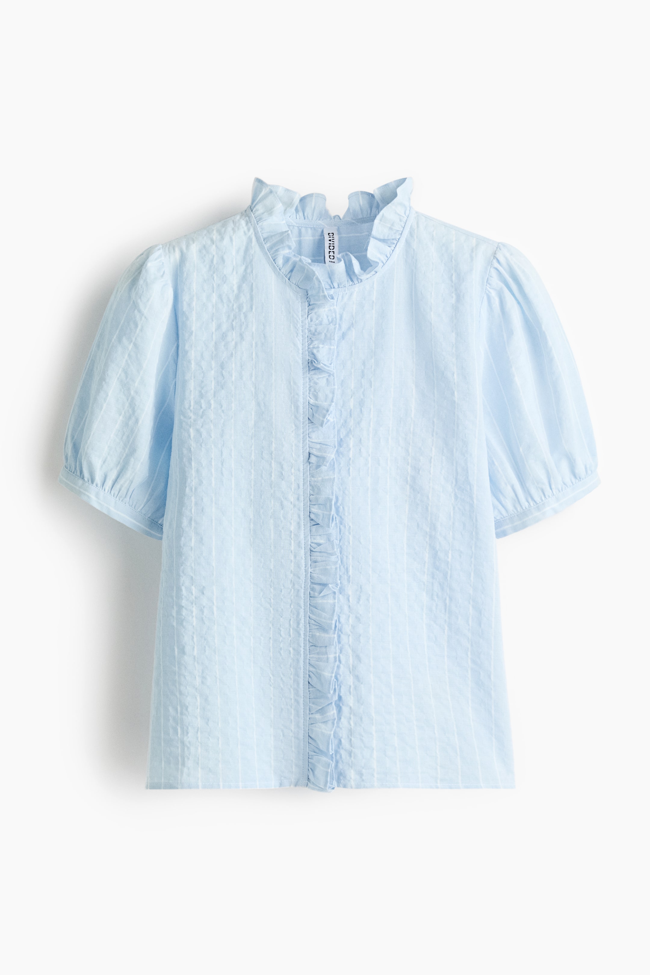 View larger image: A light blue blouse is presented front-facing, featuring a subtle vertical textured pattern.