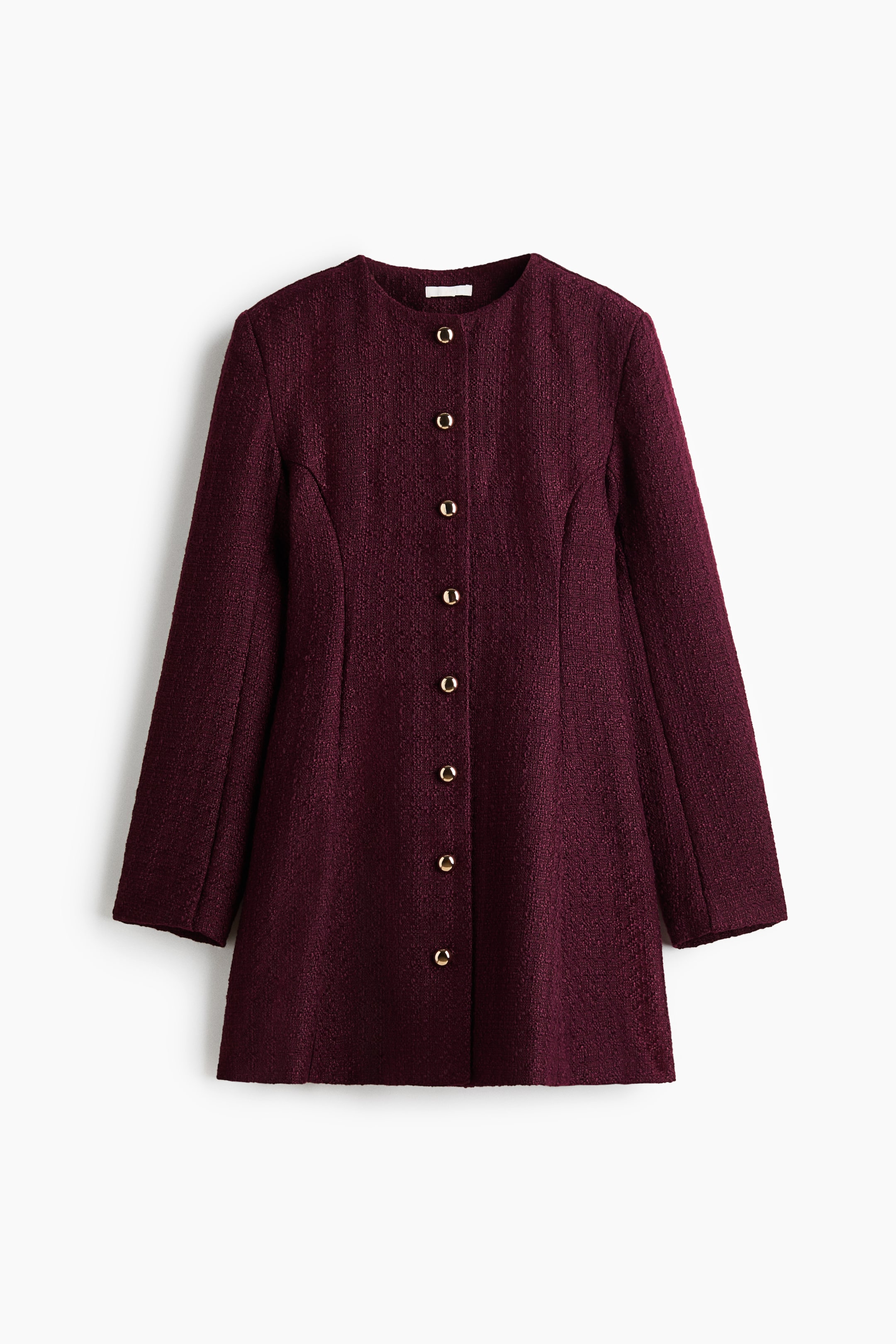 View larger image: A burgundy, collarless bouclé coat dress is shown from the front, featuring a textured fabric and a structured, slightly A-line silhouette. It has a central button closure with eight gold-tone buttons, long sleeves, and vertical princess seams.