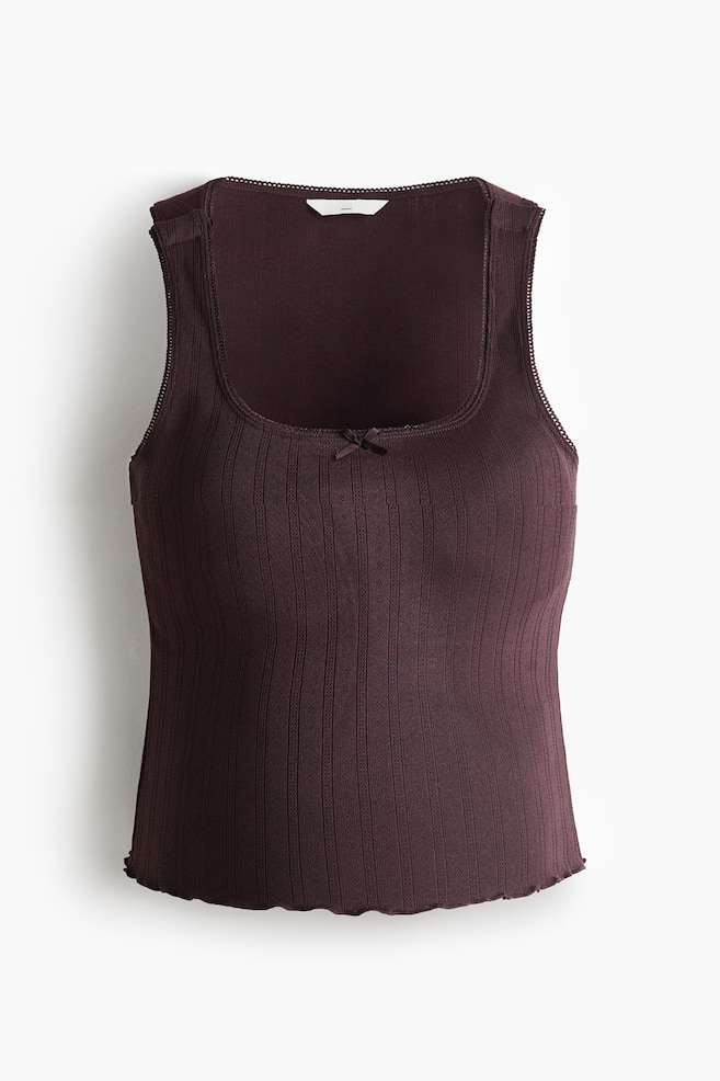 A dark brown ribbed knit tank top is shown from the front, featuring a square neckline and sleeveless armholes both outlined with scalloped lace trim. A small bow is visible at the centre front of the neckline, and the bottom edge is finished with a scalloped hem. - 1
