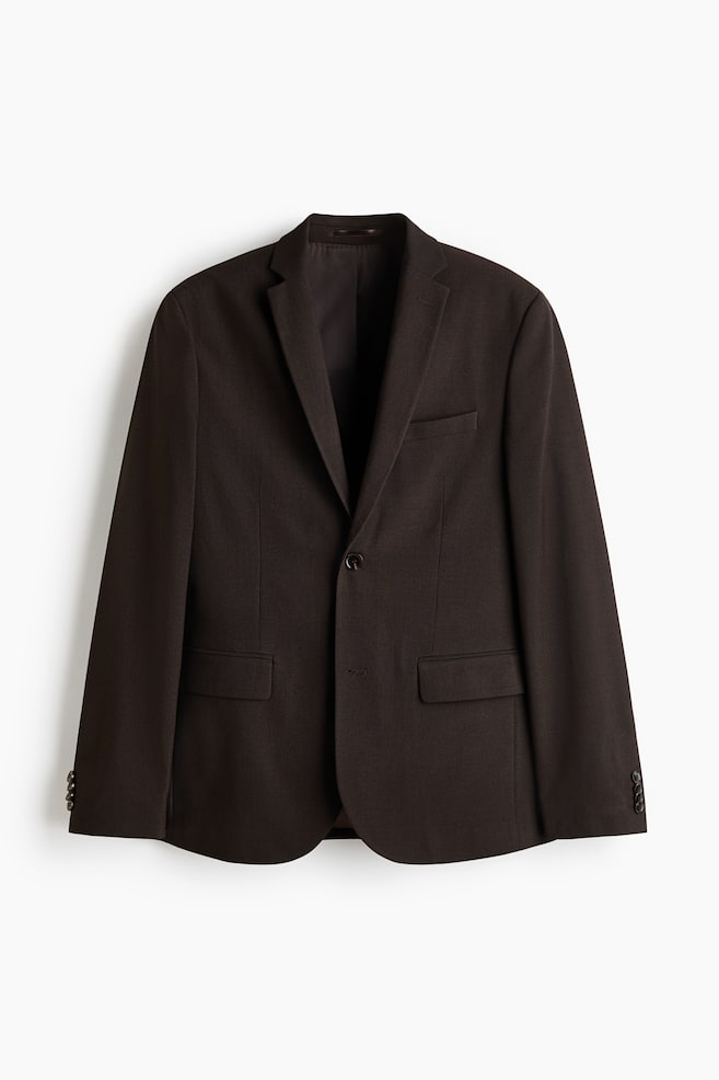 Presenting a dark brown single-breasted jacket from the front view, it showcases narrow notch lapels with a decorative buttonhole. The jacket is designed with two front buttons, a welt chest pocket, two flap front pockets, and decorative buttons on the cuffs. - 1