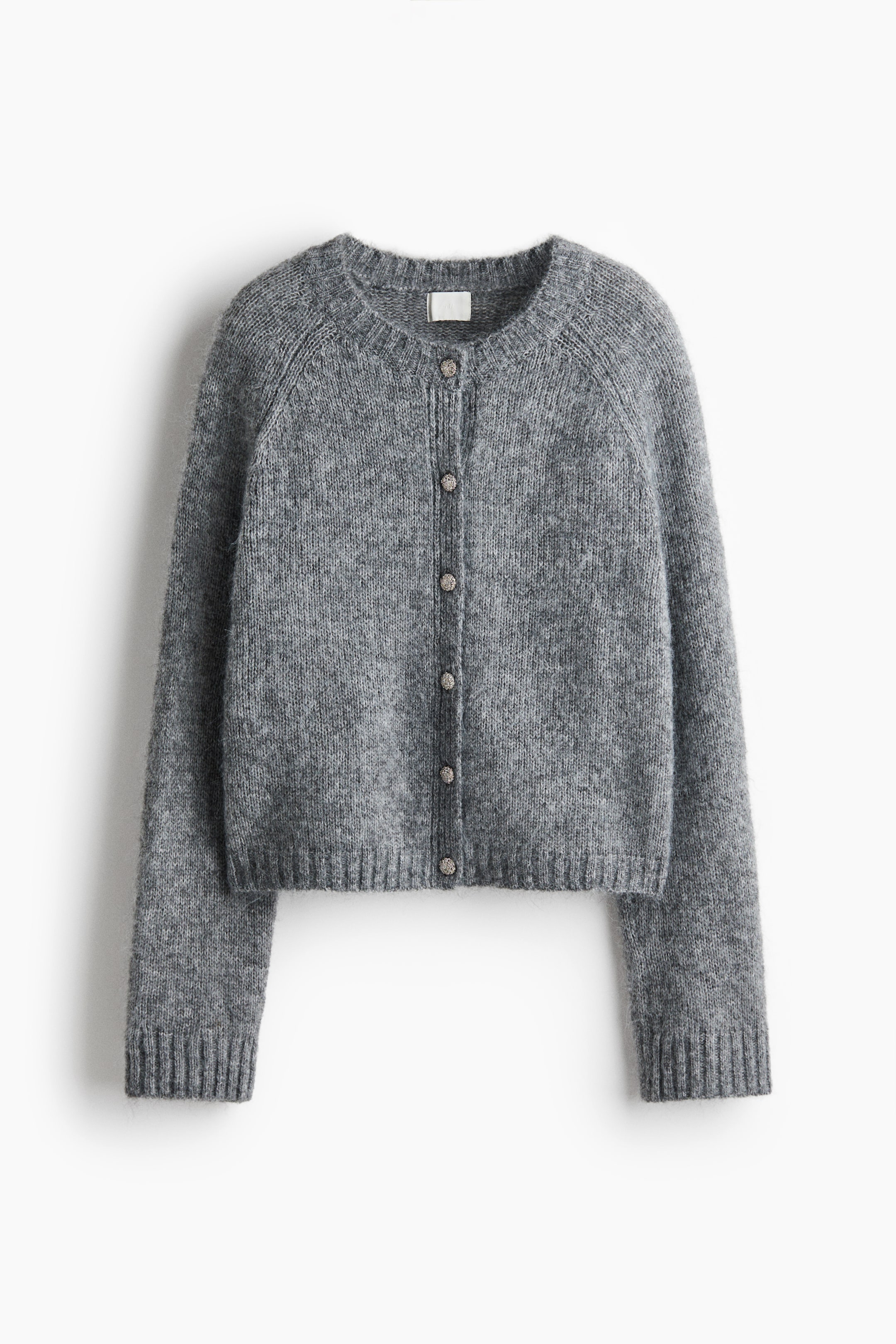 View larger image: A grey knit cardigan is facing front, showcasing its fuzzy, textured surface and raglan sleeves. It features a crew neck, six small round buttons down the front, and ribbed detailing along the collar, hem, and cuffs.