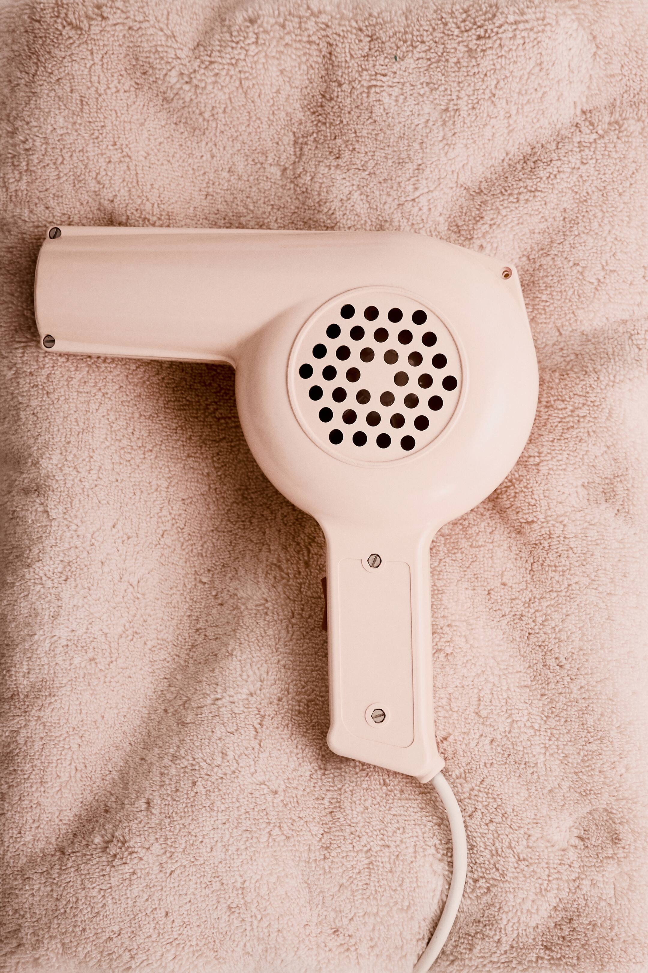 View larger image: A light pink bath towel is displaying a soft, fluffy terry texture.