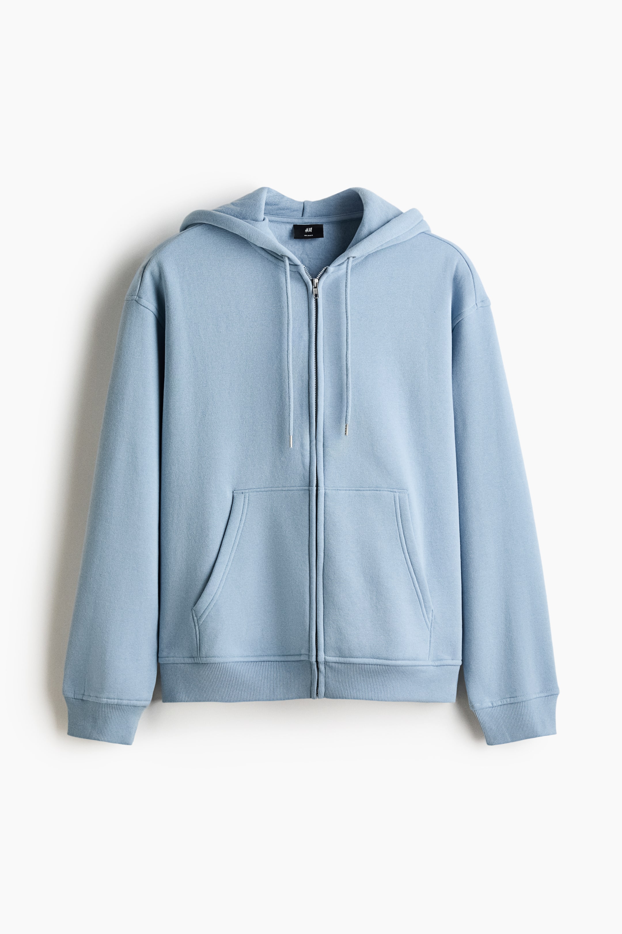 View larger image: A light blue zip-up hoodie is shown from the front, featuring a hood with a drawstring, a zip closure, and front patch pockets. It is designed with dropped shoulders, long sleeves, ribbed cuffs, and a ribbed hem, offering a relaxed fit.